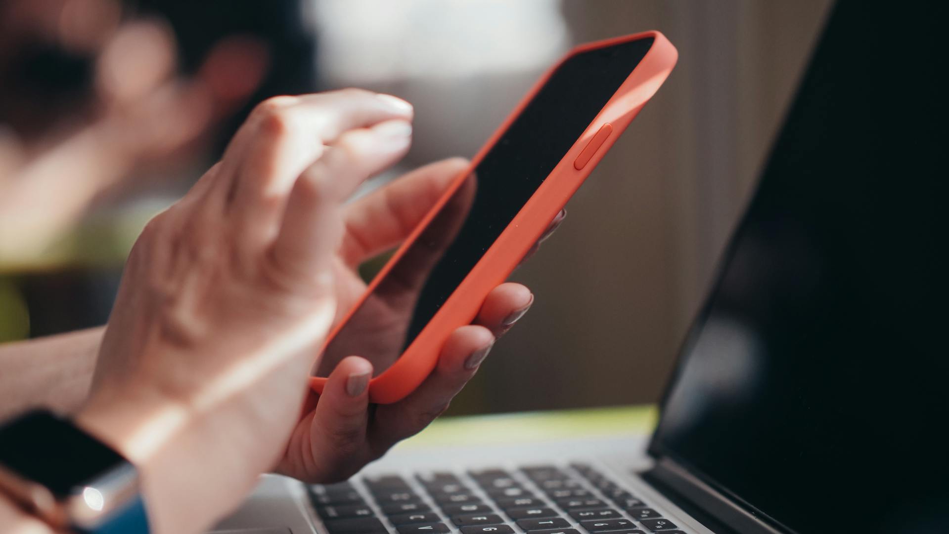 A woman using her phone at work | Source: Pexels