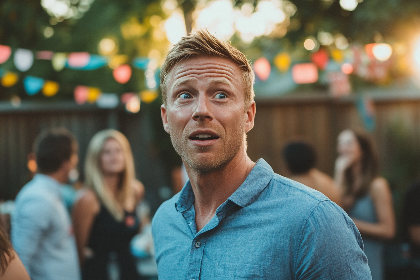 Shocked man at a backyard birthday party | Source: Midjourney