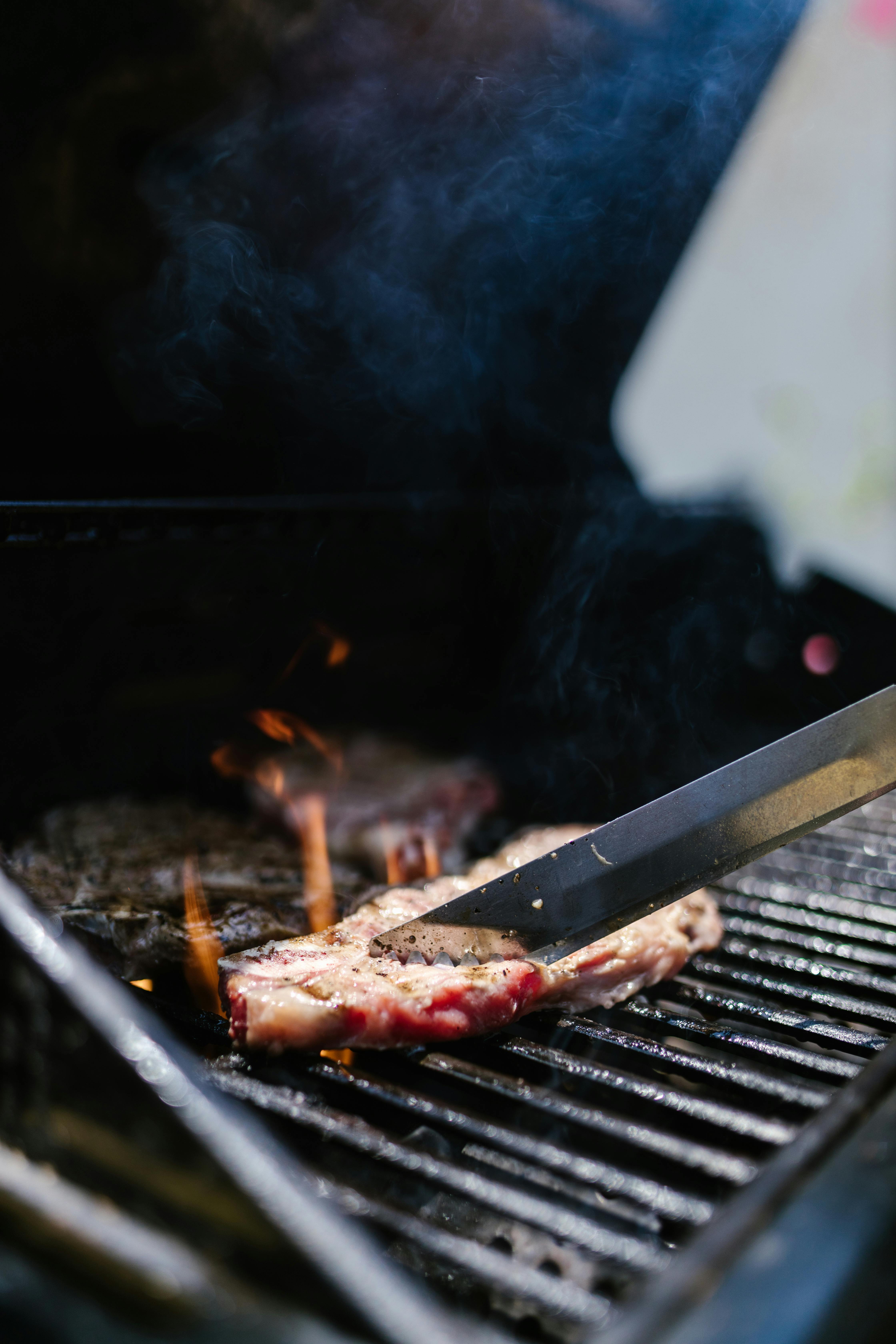 A piece of meat on a barbecue | Source: Pexels