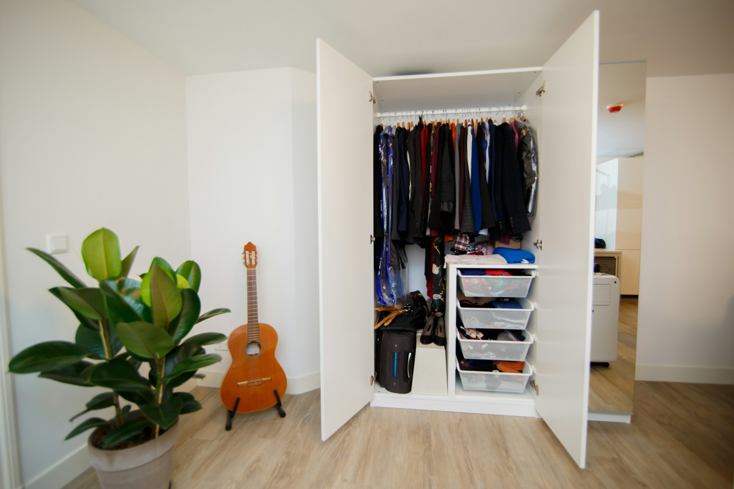 A bag stored in the corner of a bedroom closet | Source: Unsplash