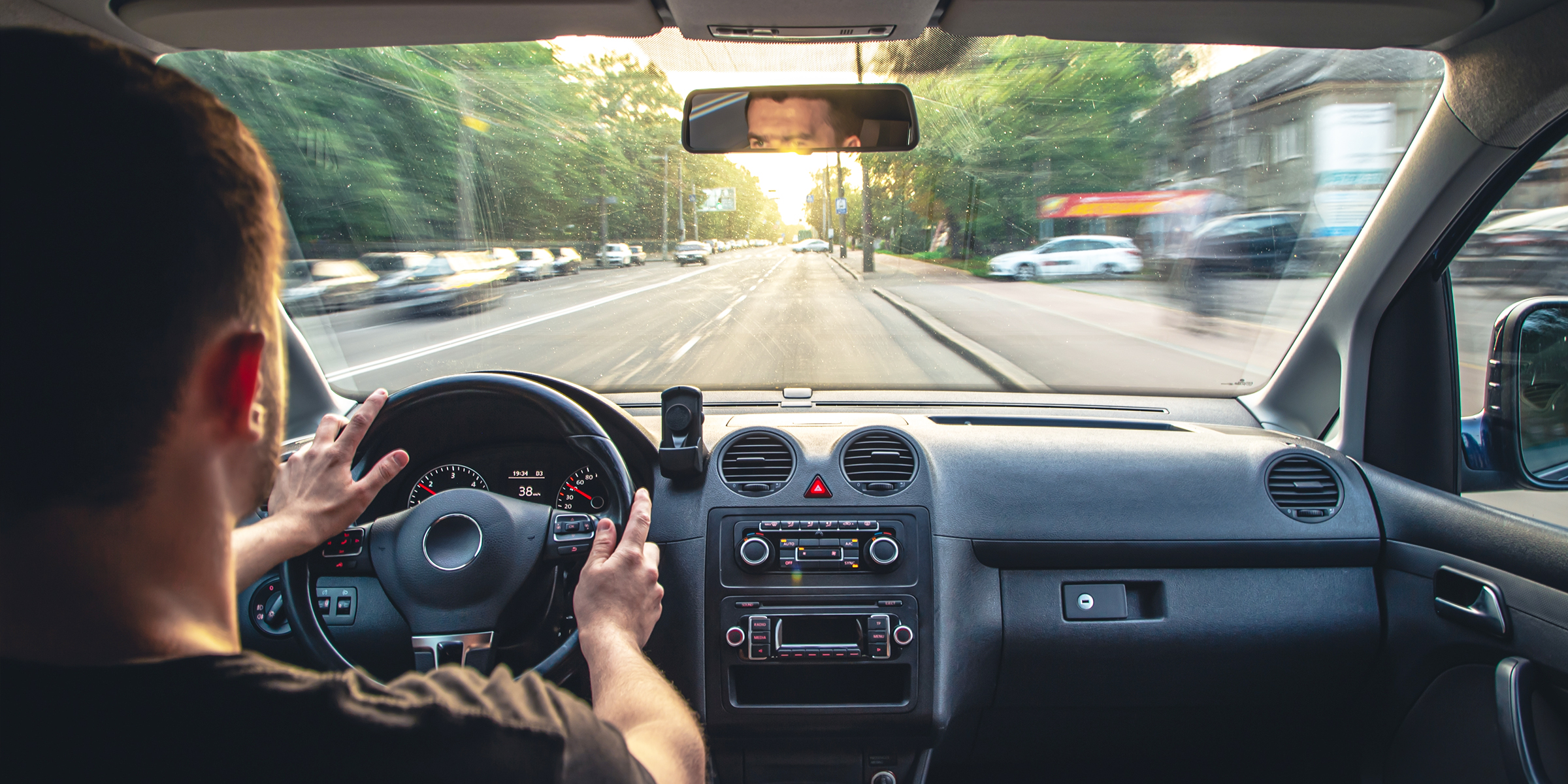 A man driving through a city | Source: Shutterstock