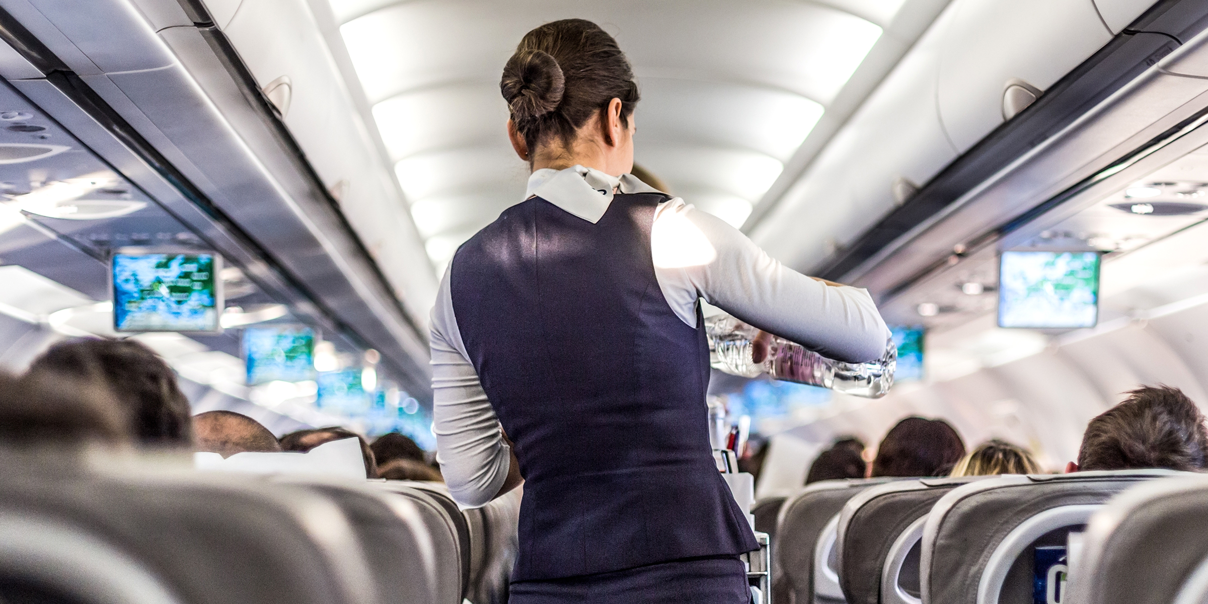 A flight attendant on a plane | Source: Shutterstock