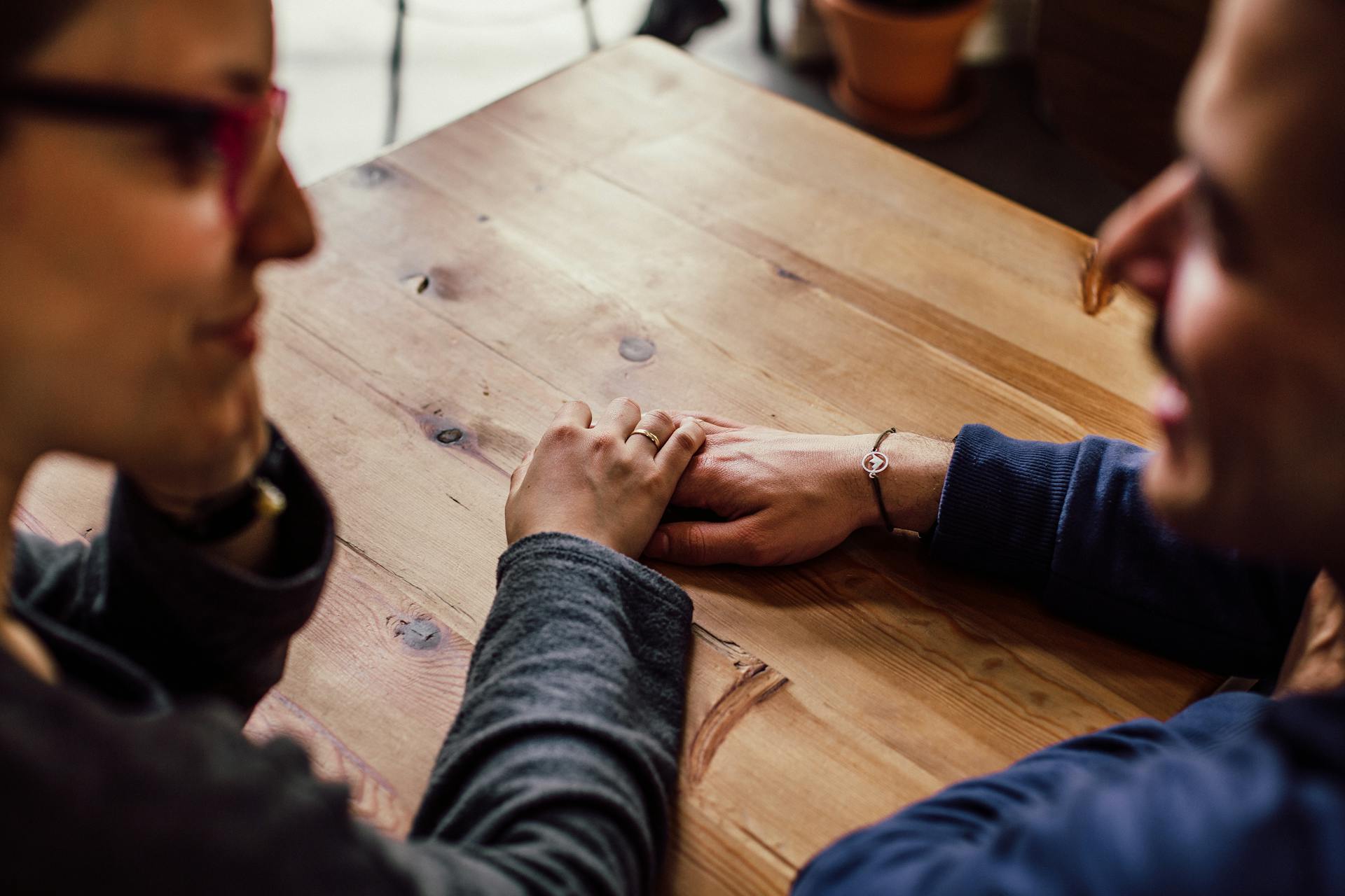 A couple touching hands | Source: Pexels