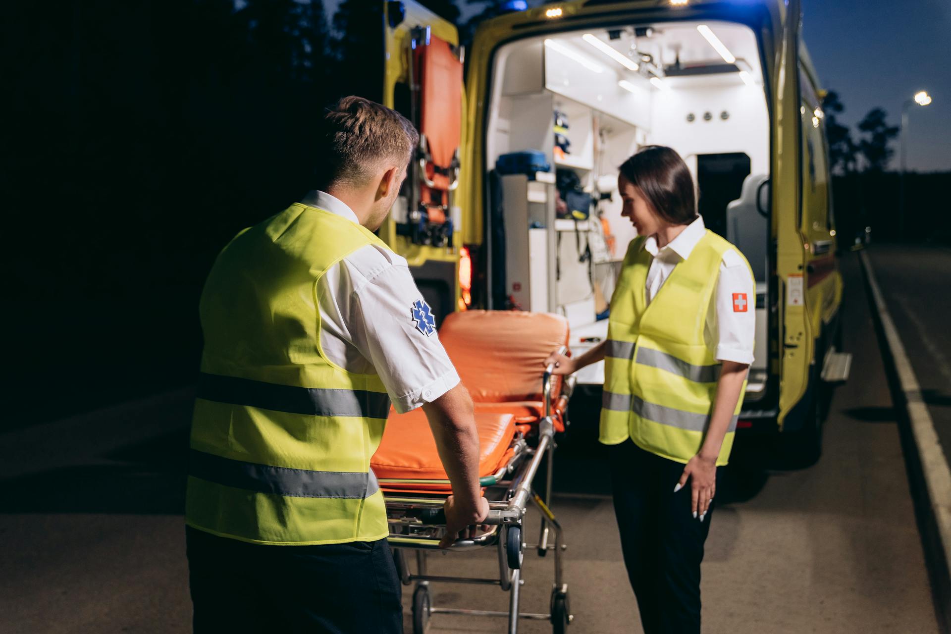 Paramedics standing near a stretcher | Source: Pexels