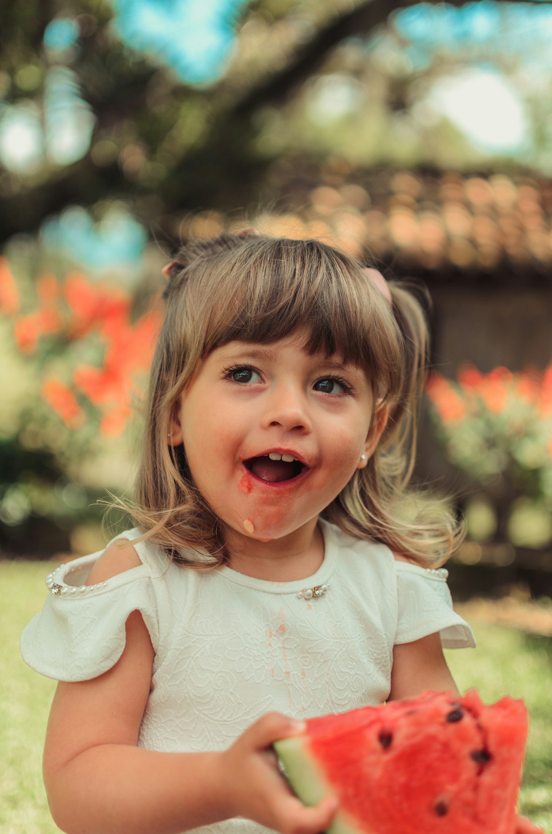 A delighted little girl eating watermelon | Source: Unsplash