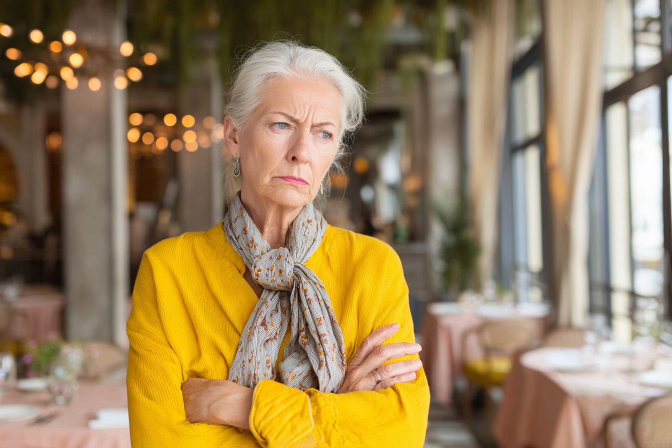 An irate woman standing in a hotel restaurant | Source: Midjourney