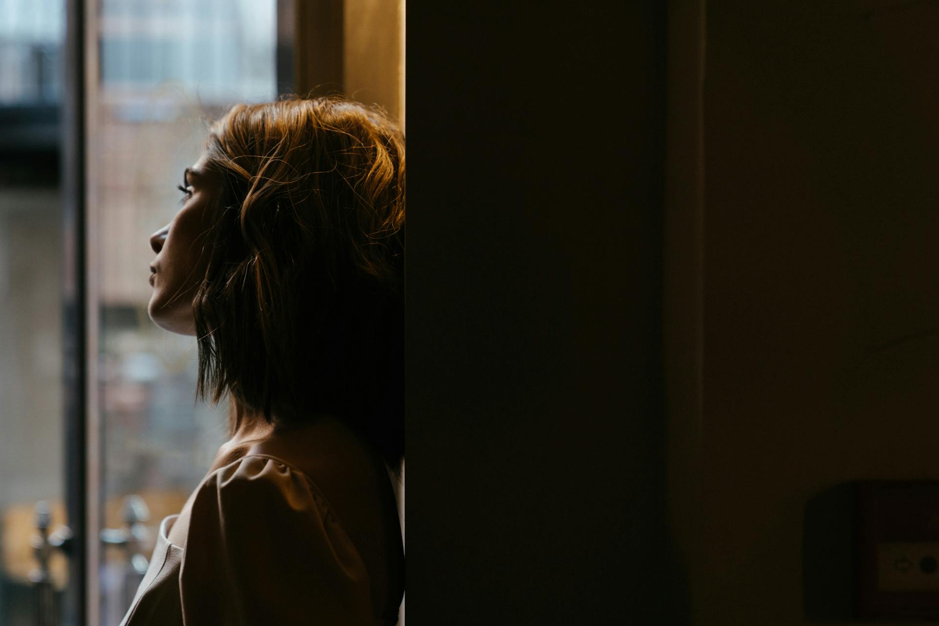 A woman looking out the window | Source: Pexels