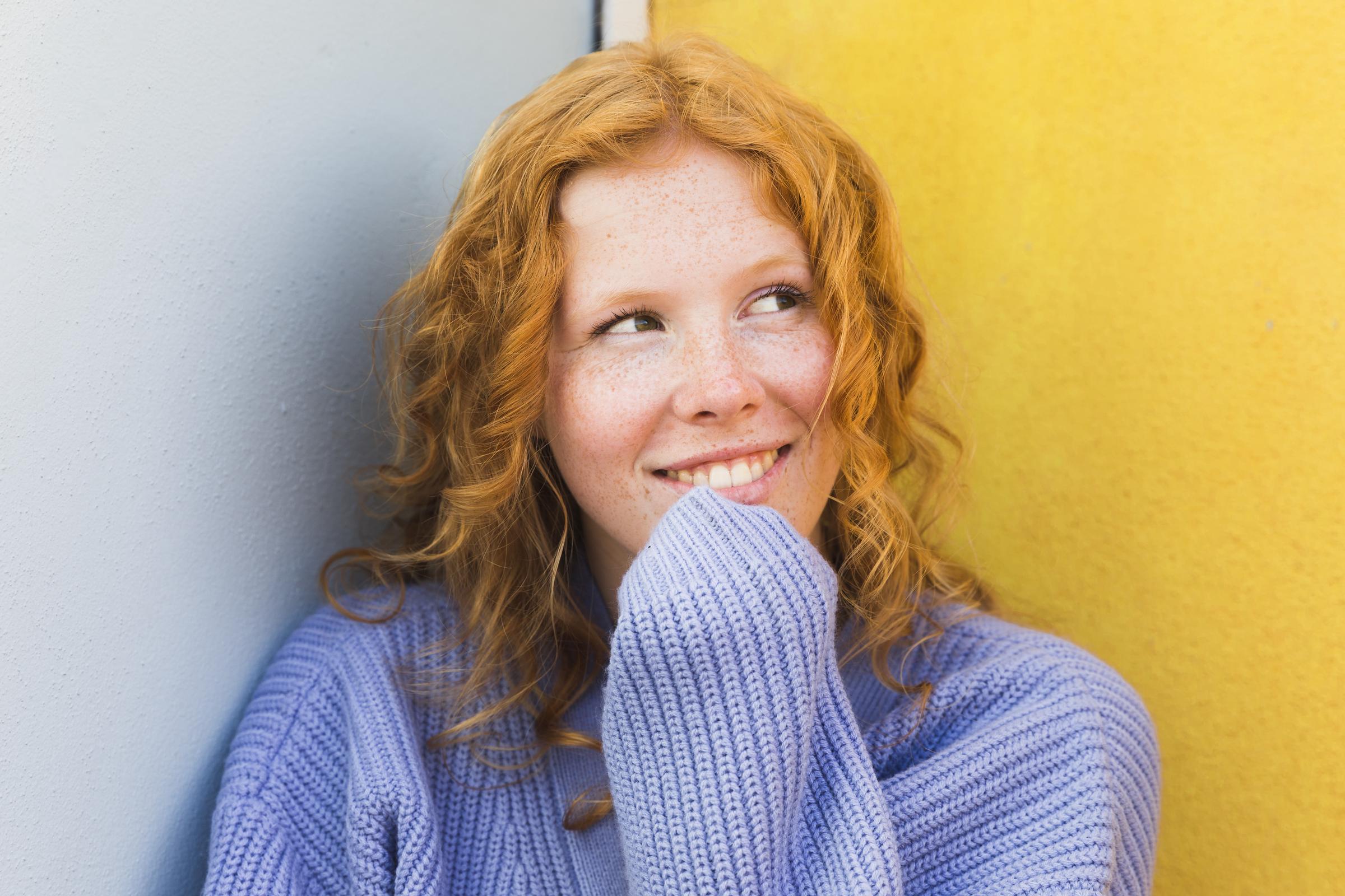 A happy woman deep in thought | Source: Freepik