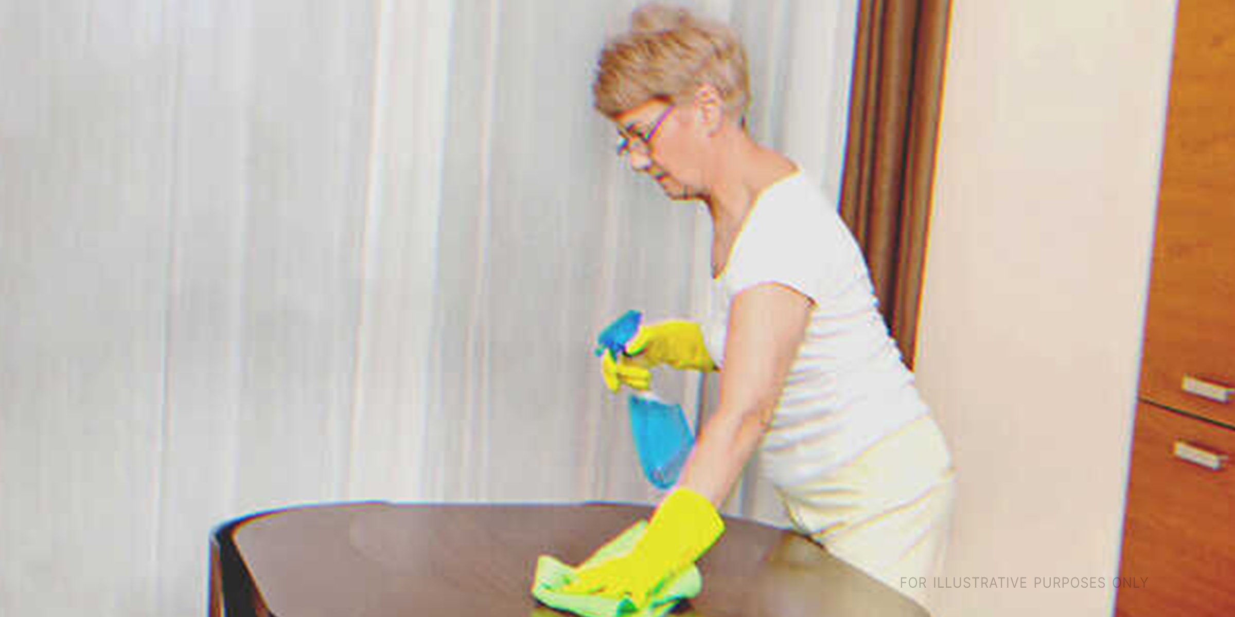 Old Woman Cleaning A Table. | Source: Shutterstock