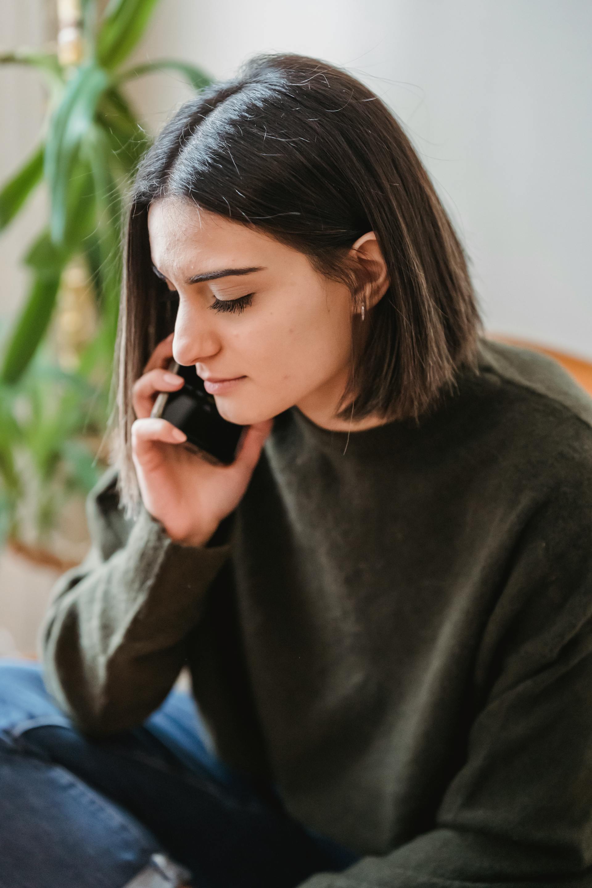 A woman frowning during a phone call | Source: Pexels