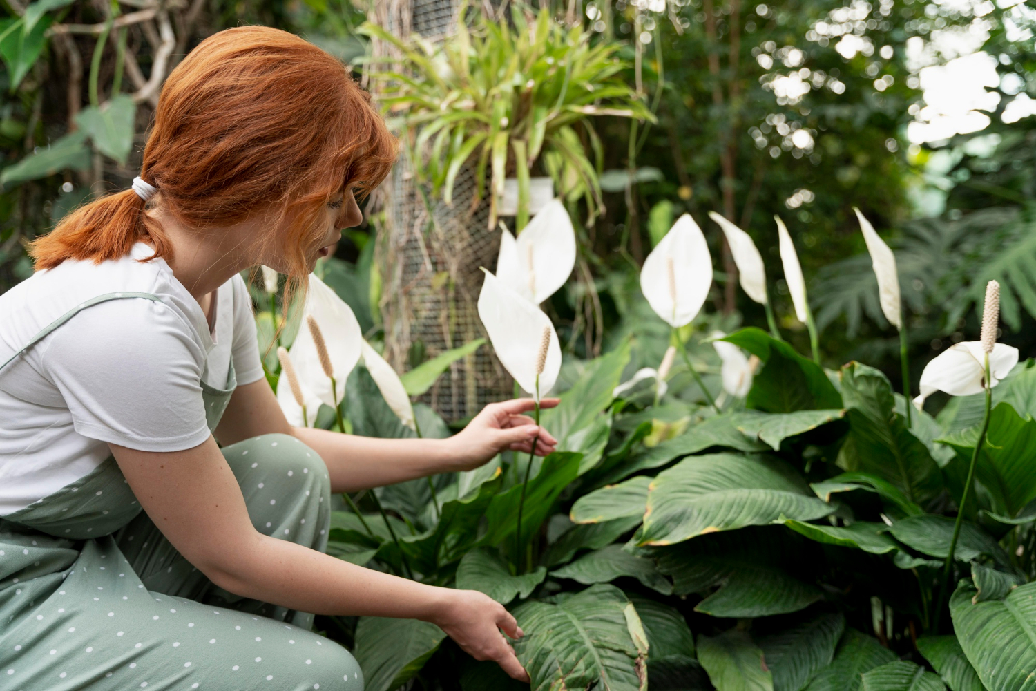 A young woman tending to plants in a garden | Source: Freepik