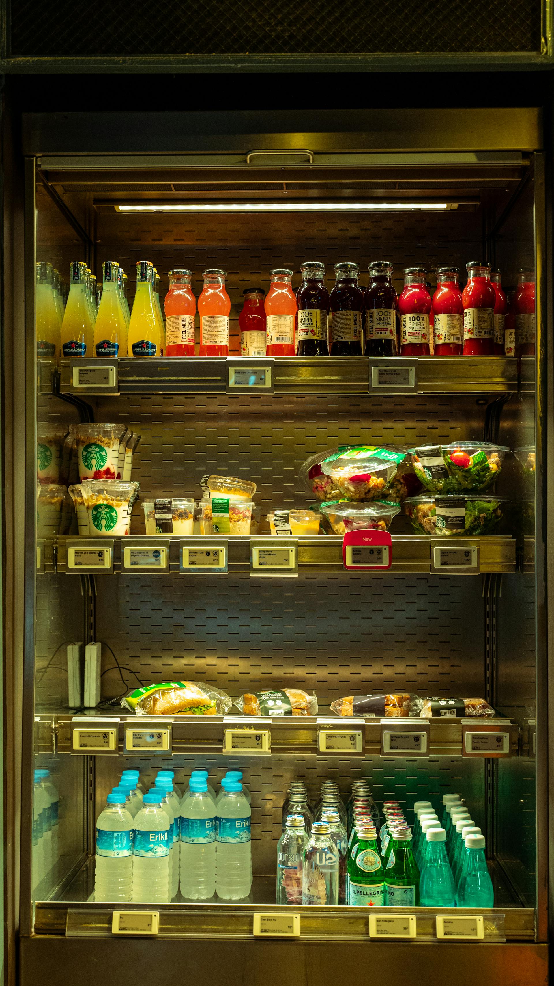 A fridge in a convenience store with several food items | Source: Pexels