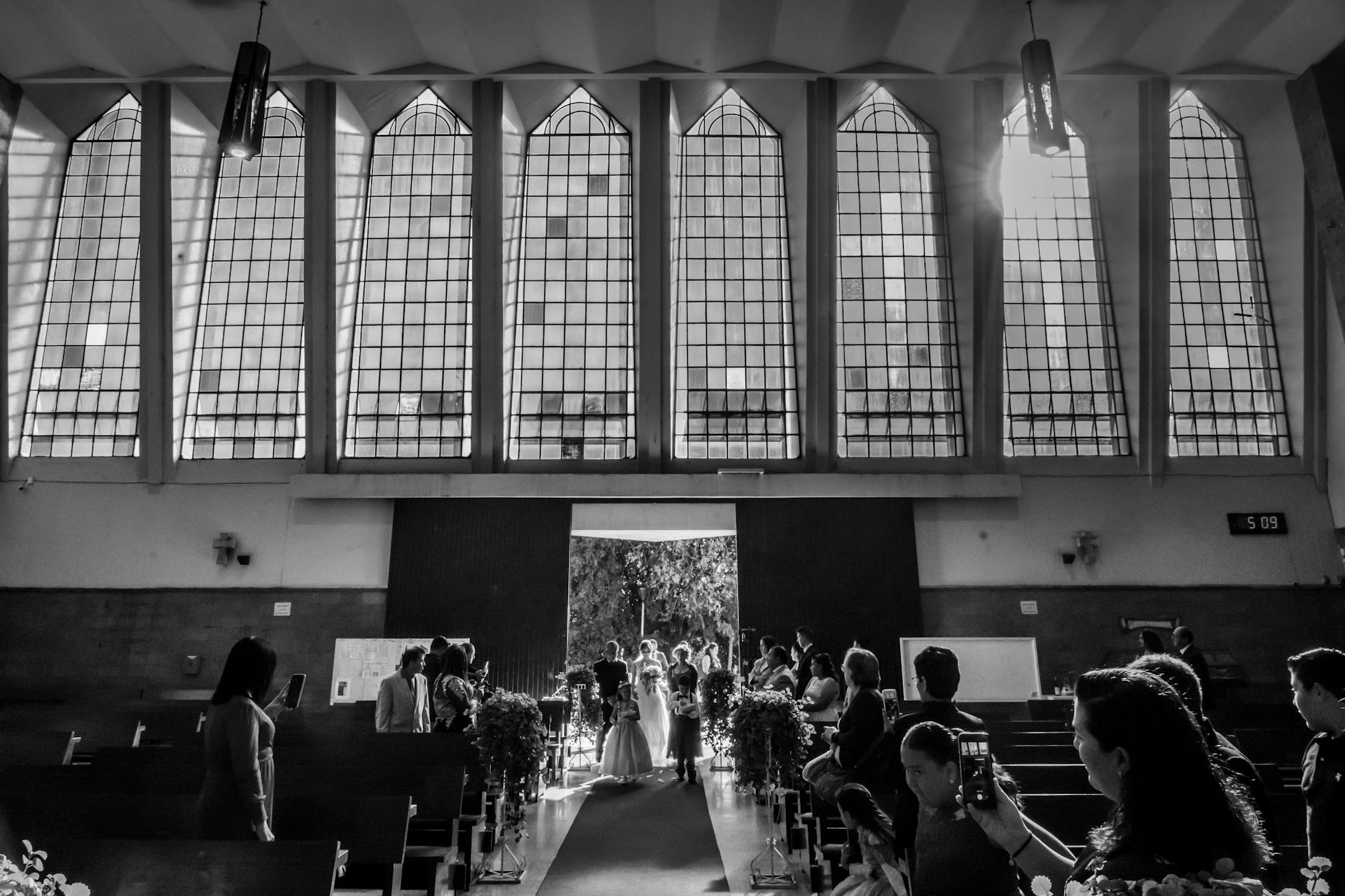 Grayscale shot of guests at a wedding ceremony | Source: Pexels