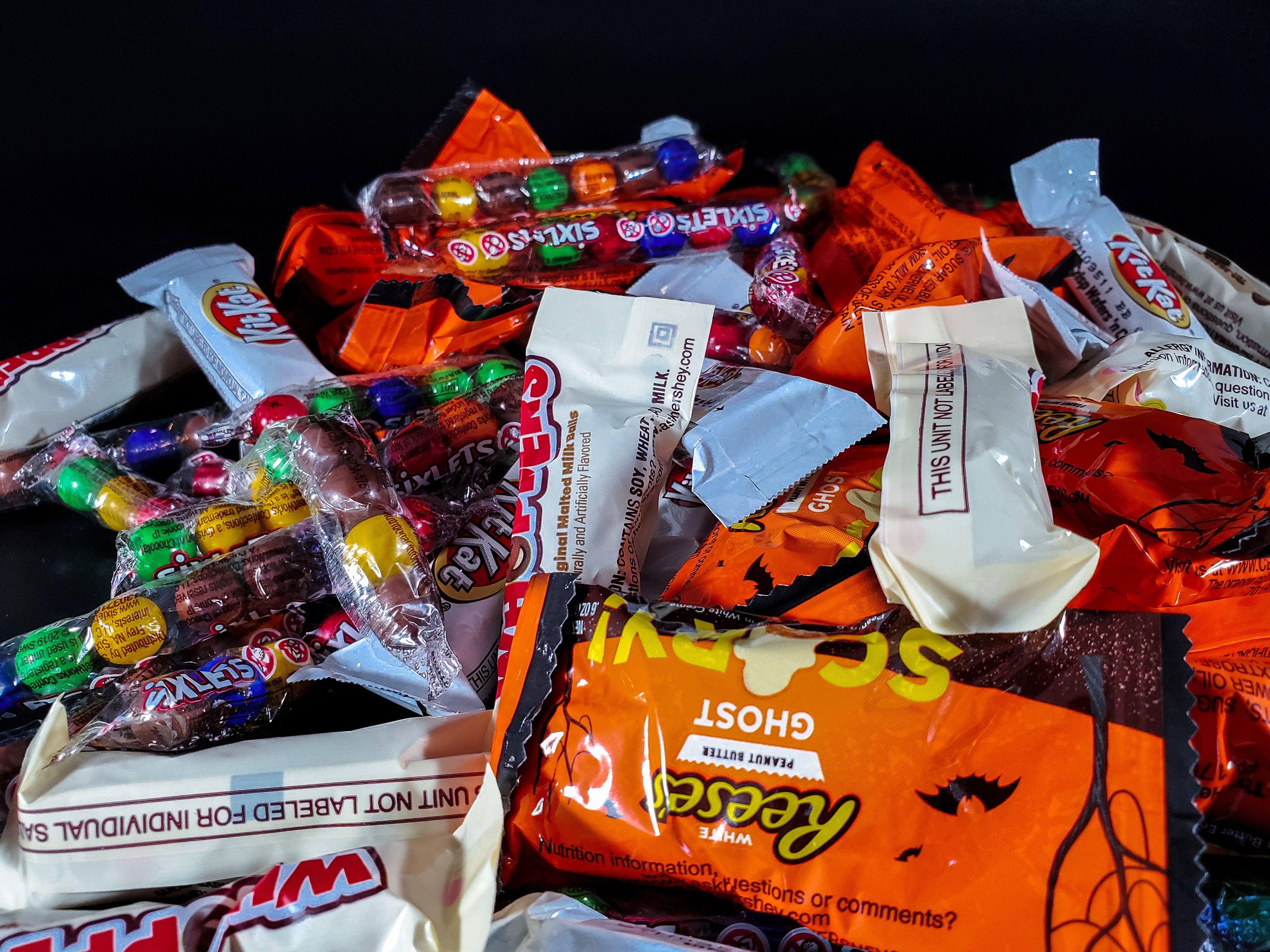 A vibrant stack of colorful Halloween candy wrappers | Source: Pexels
