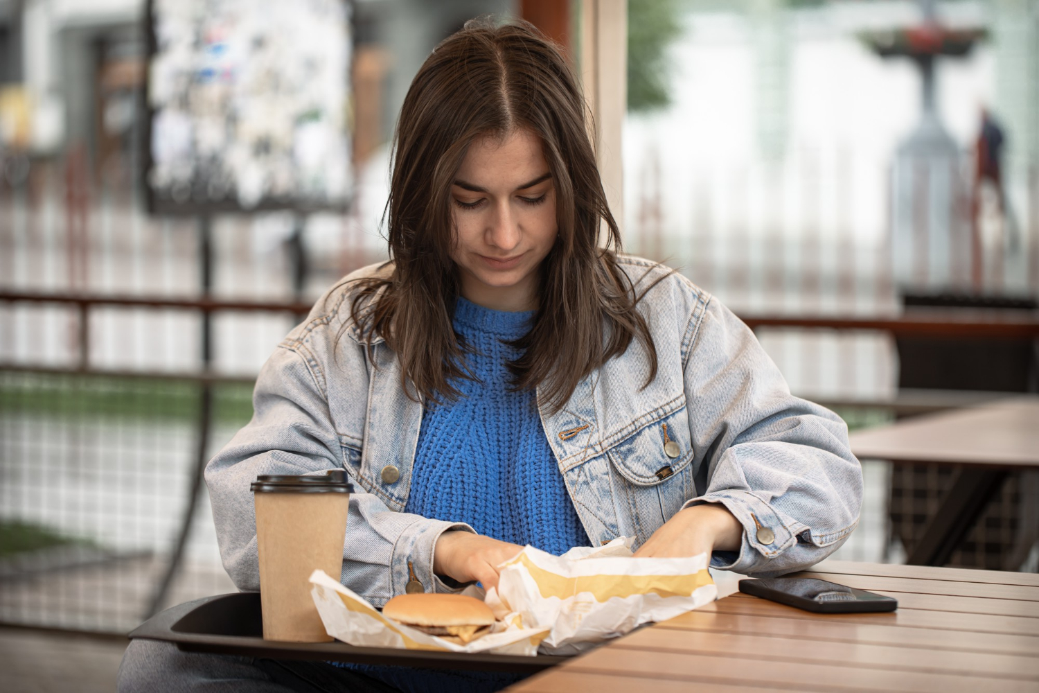 A distressed young woman having her meal | Source: Freepik