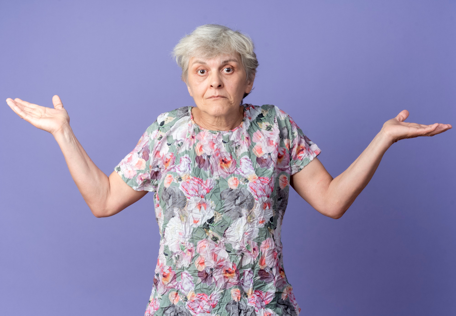 An elderly woman shrugging | Source: Freepik
