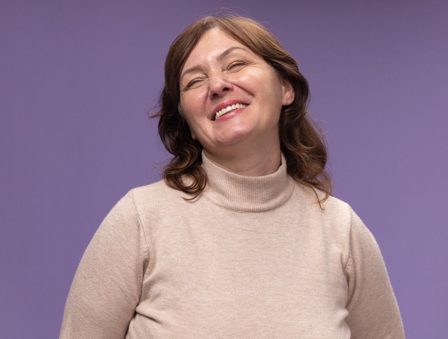 A senior woman laughing | Source: Freepik