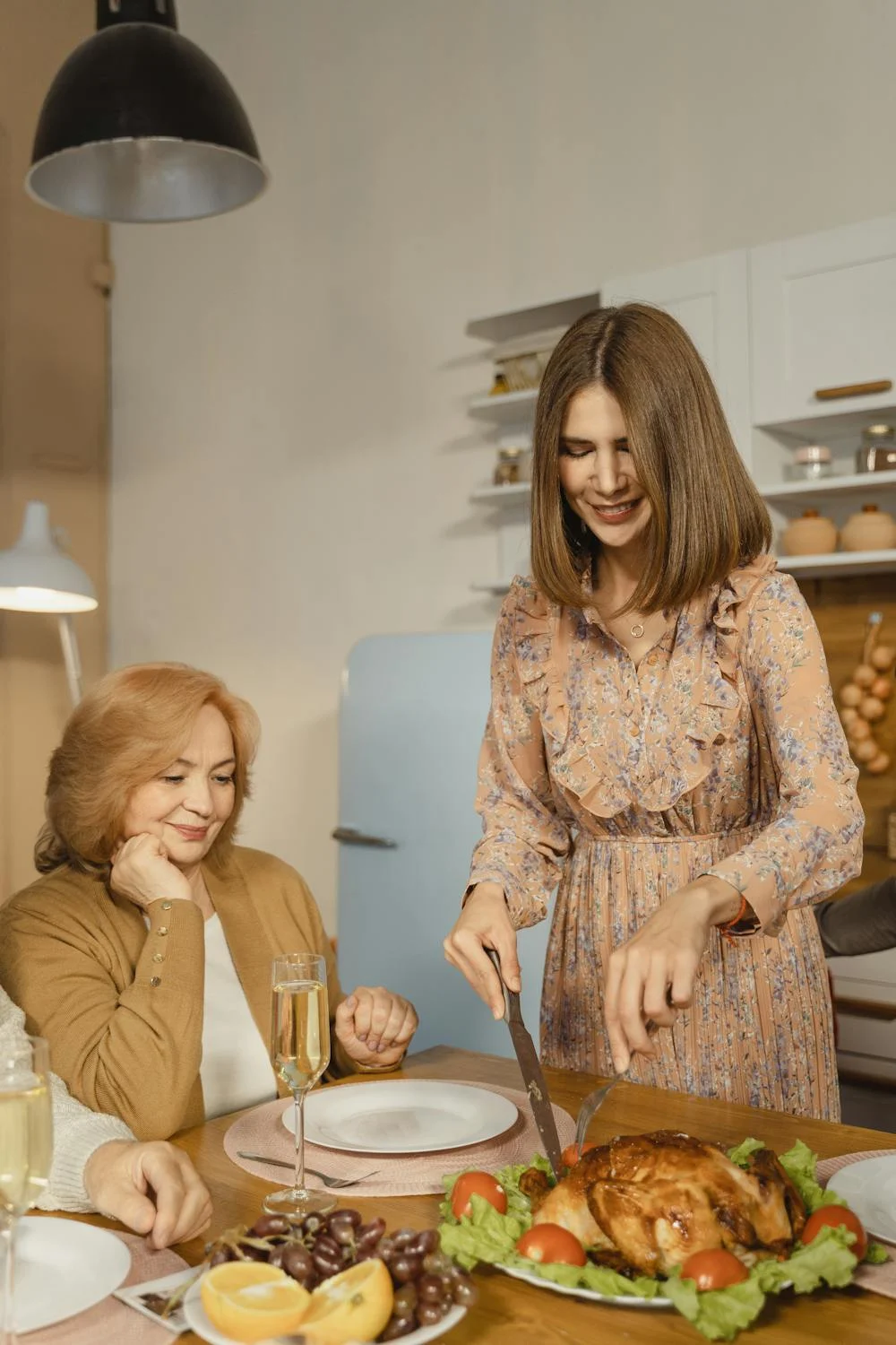 A woman serving dinner to her mother-in-law | Source: Pexels