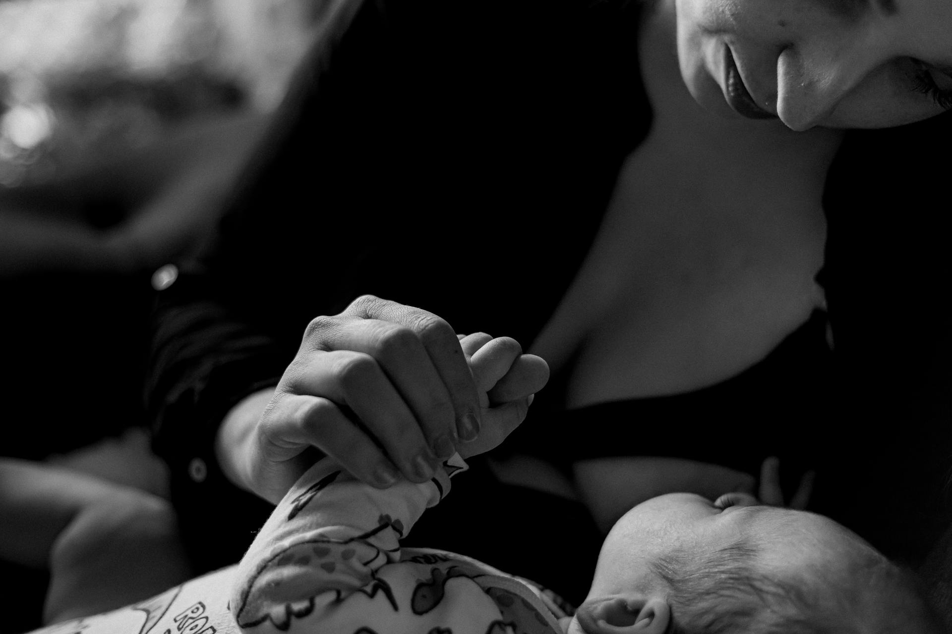 A grayscale photo of a woman holding her baby | Source: Pexels