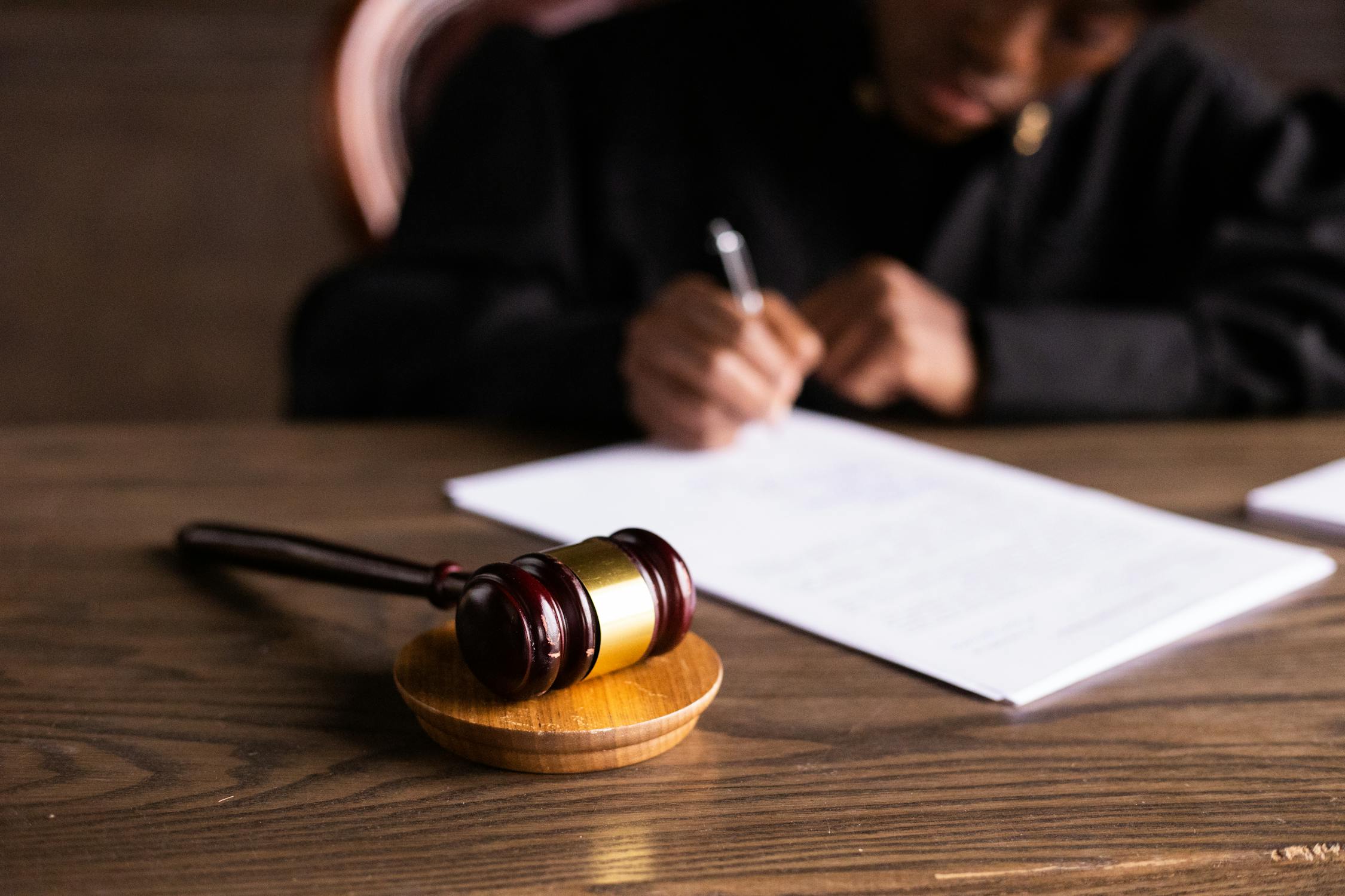A judge signing a document | Source: Pexels