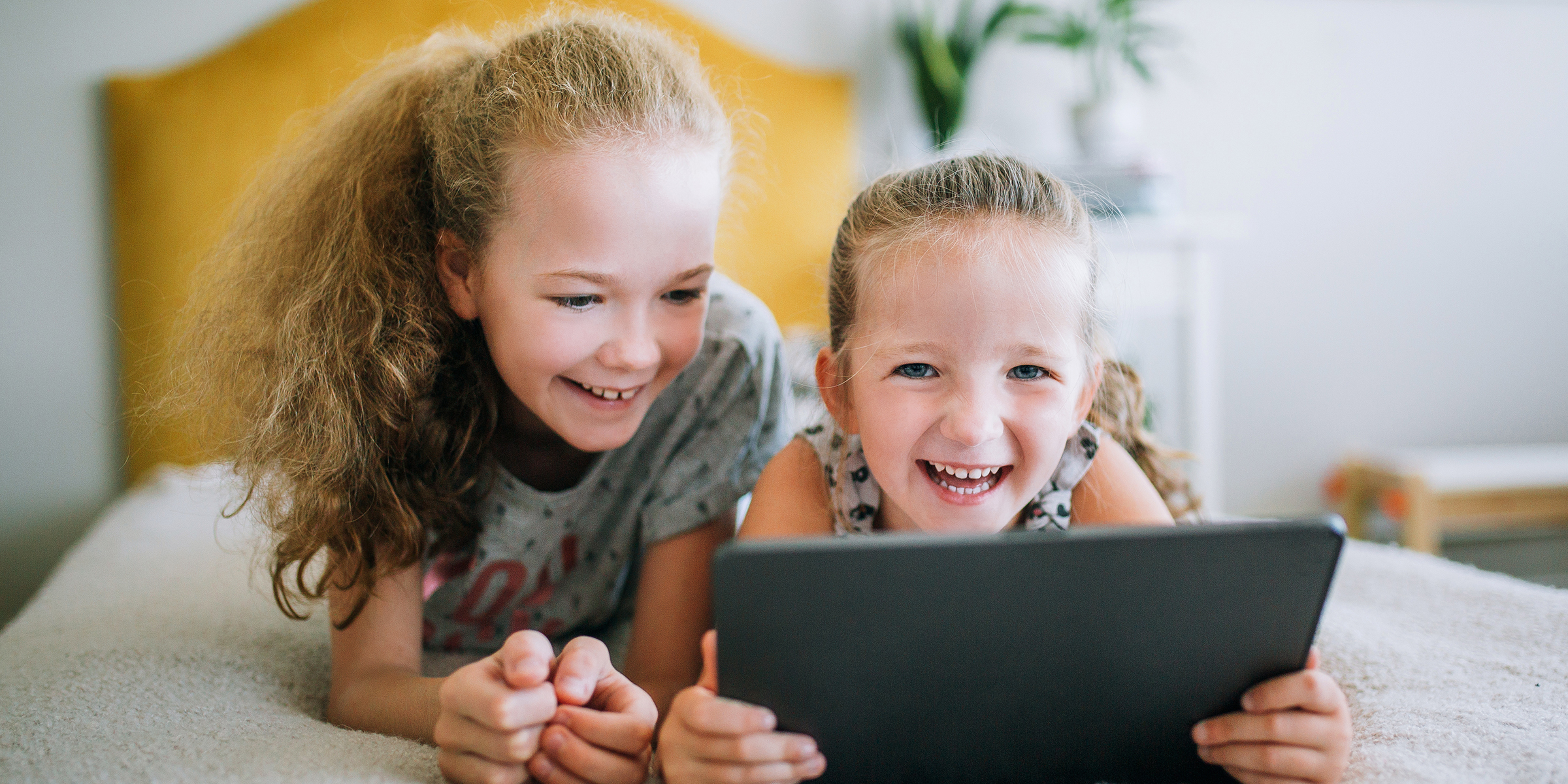 Children playing with an iPad | Source: Shutterstock