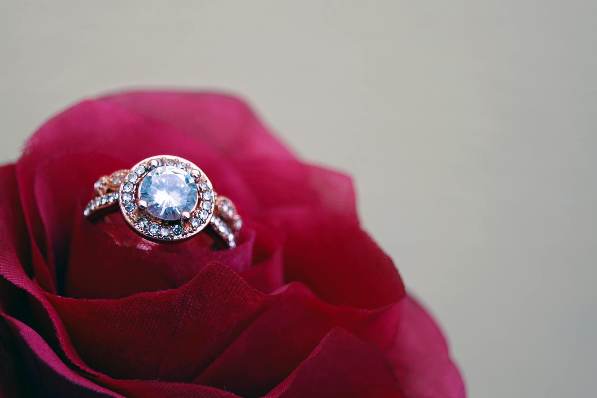 A diamond ring nestled inside a red rose | Source: Pexels