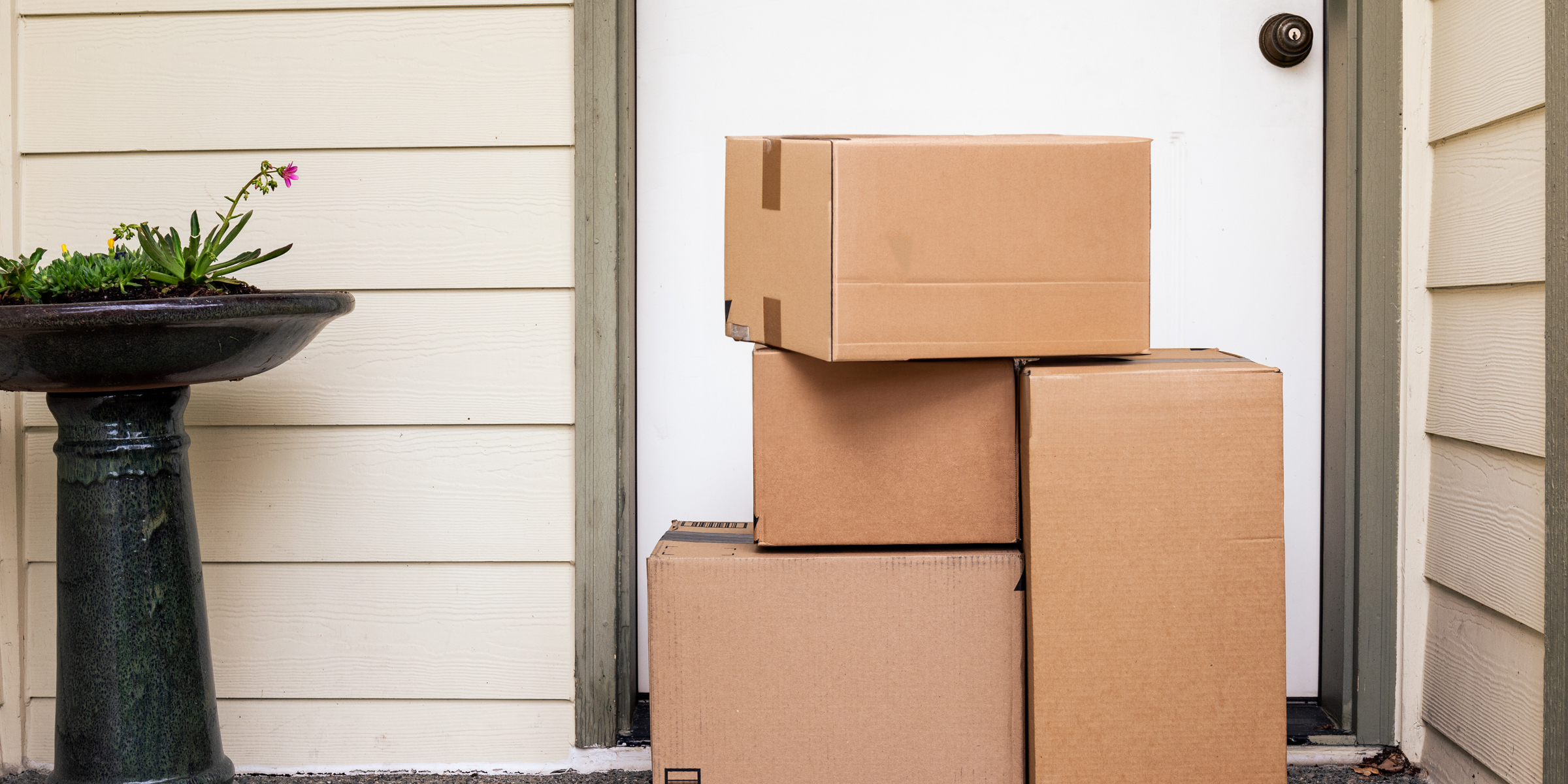 Cardboard boxes outside a front door | Source: Shutterstock