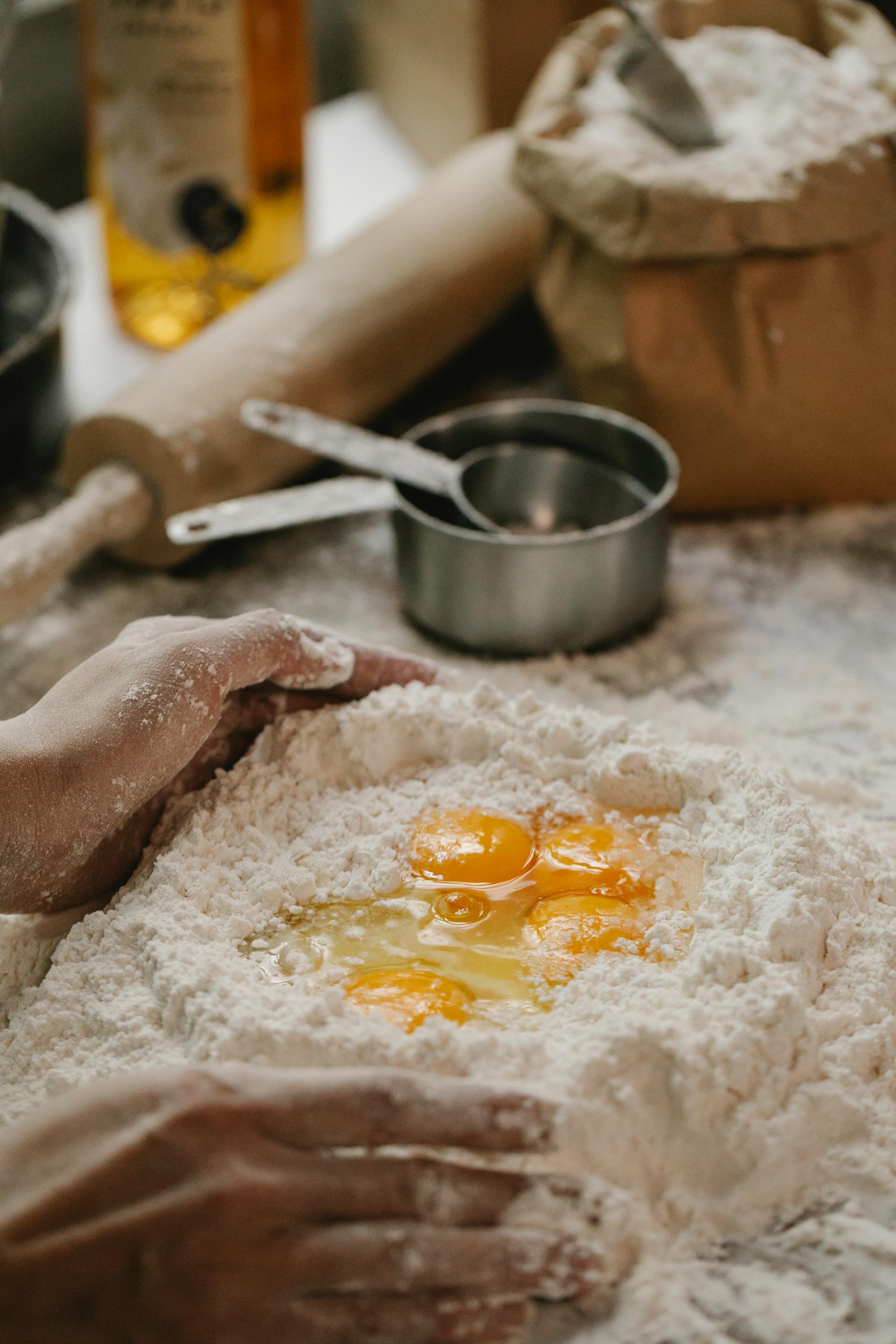 Cropped shot of a woman making dough in the kitchen | Source: Pexels