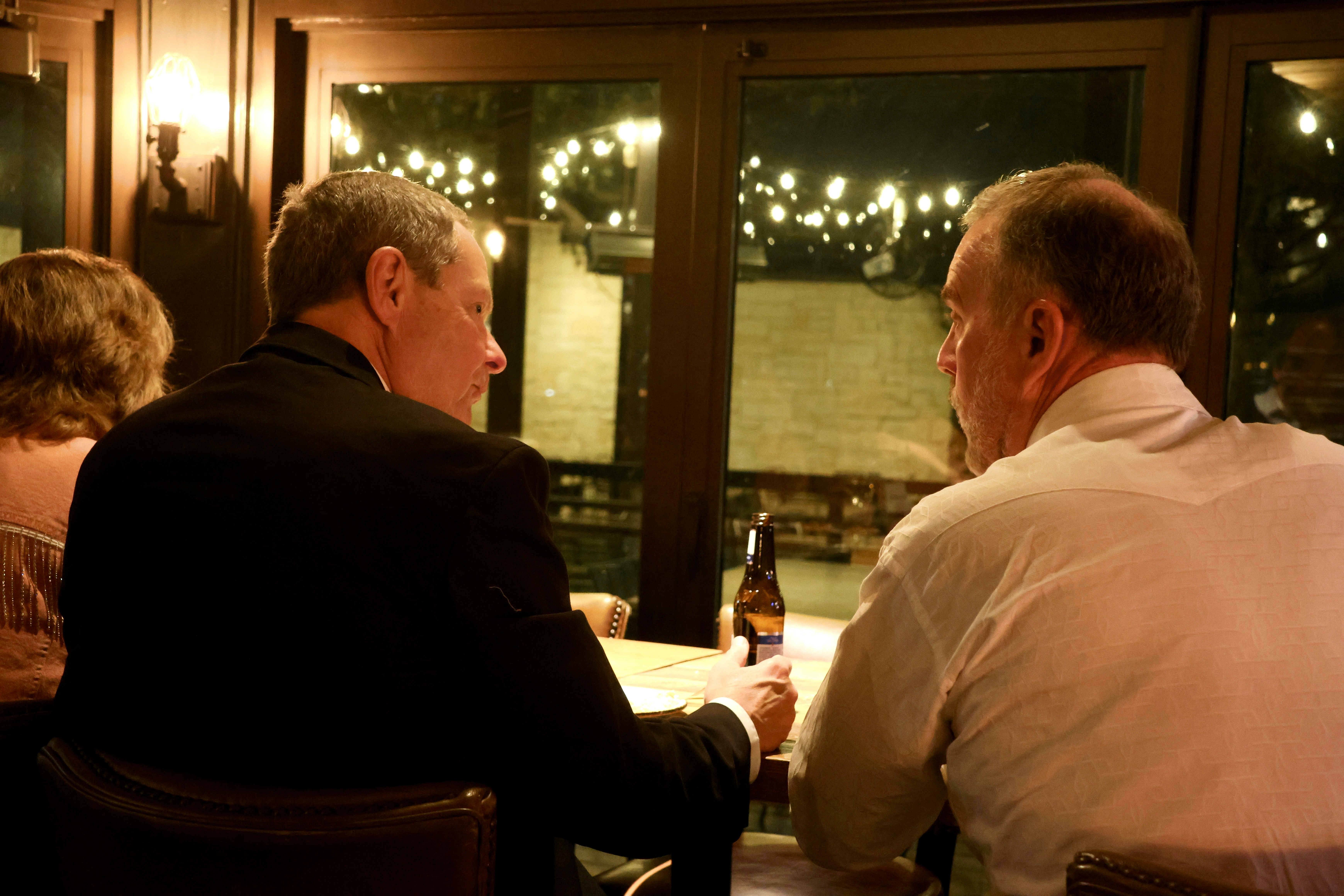 Men sitting at a table talking | Source: Unsplash
