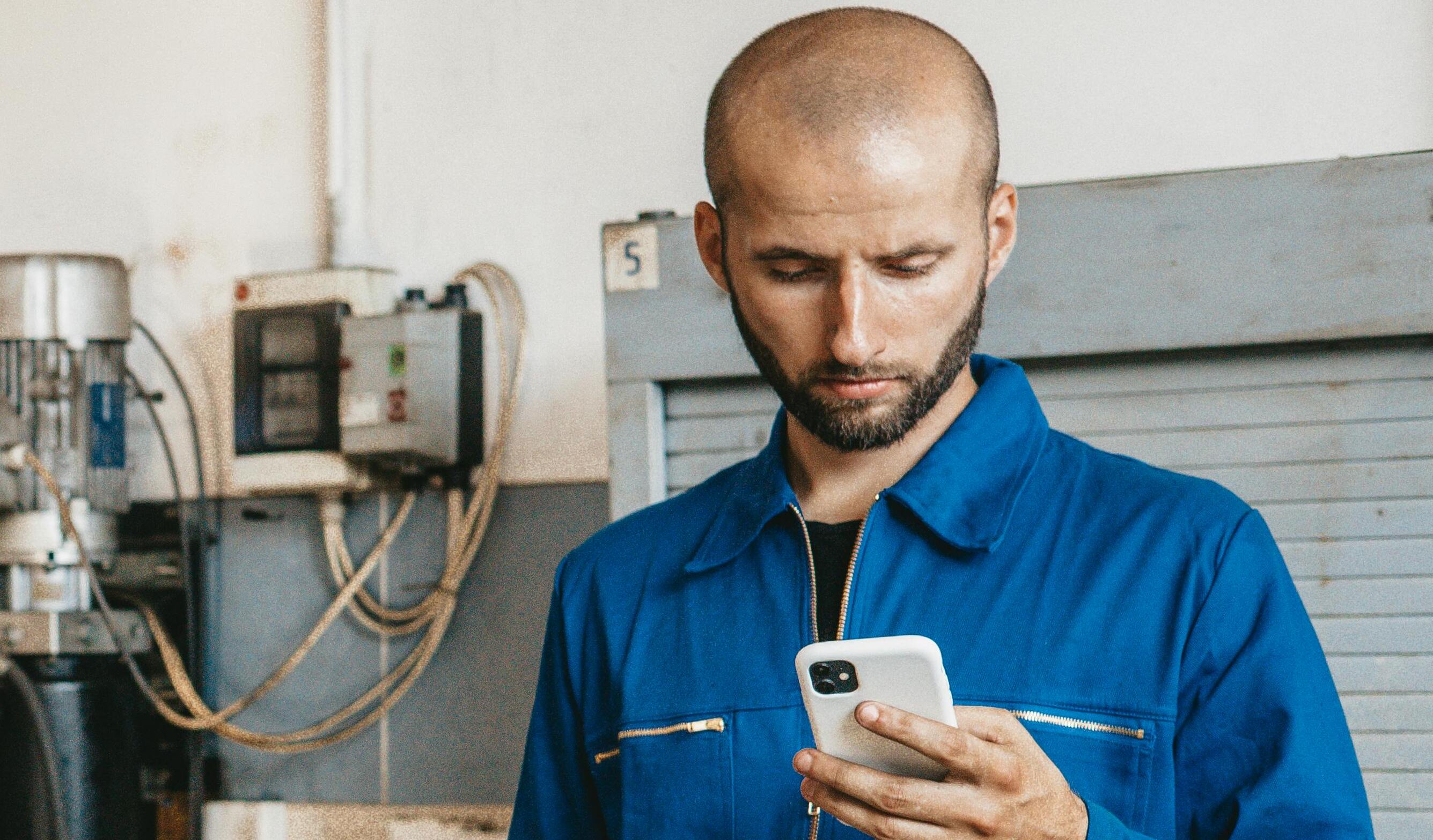 A man in uniform checking his phone | Source: Pexels