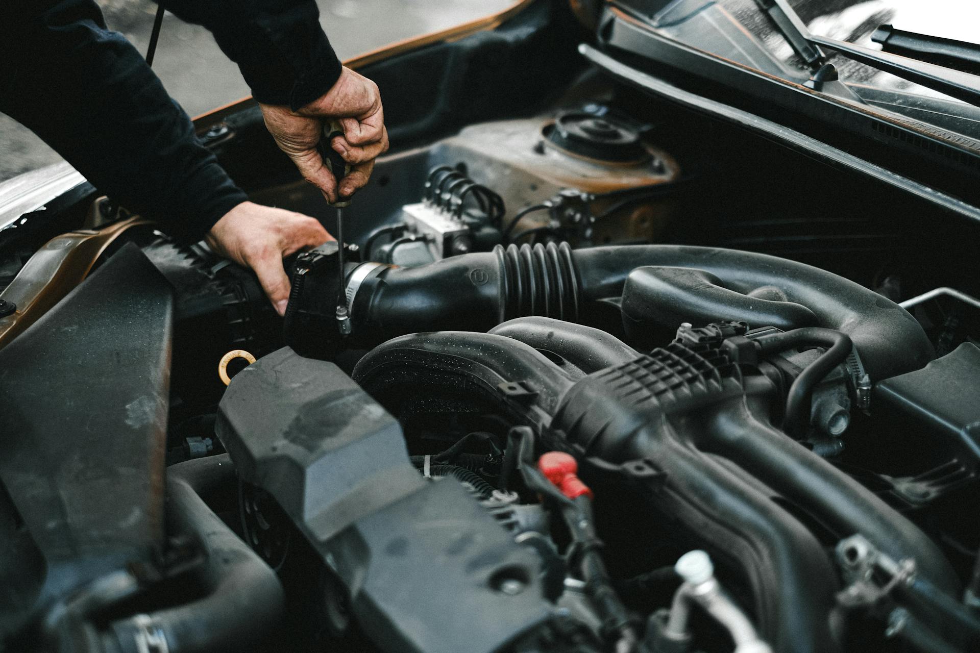 A man checking a car engine | Source: Midjourney