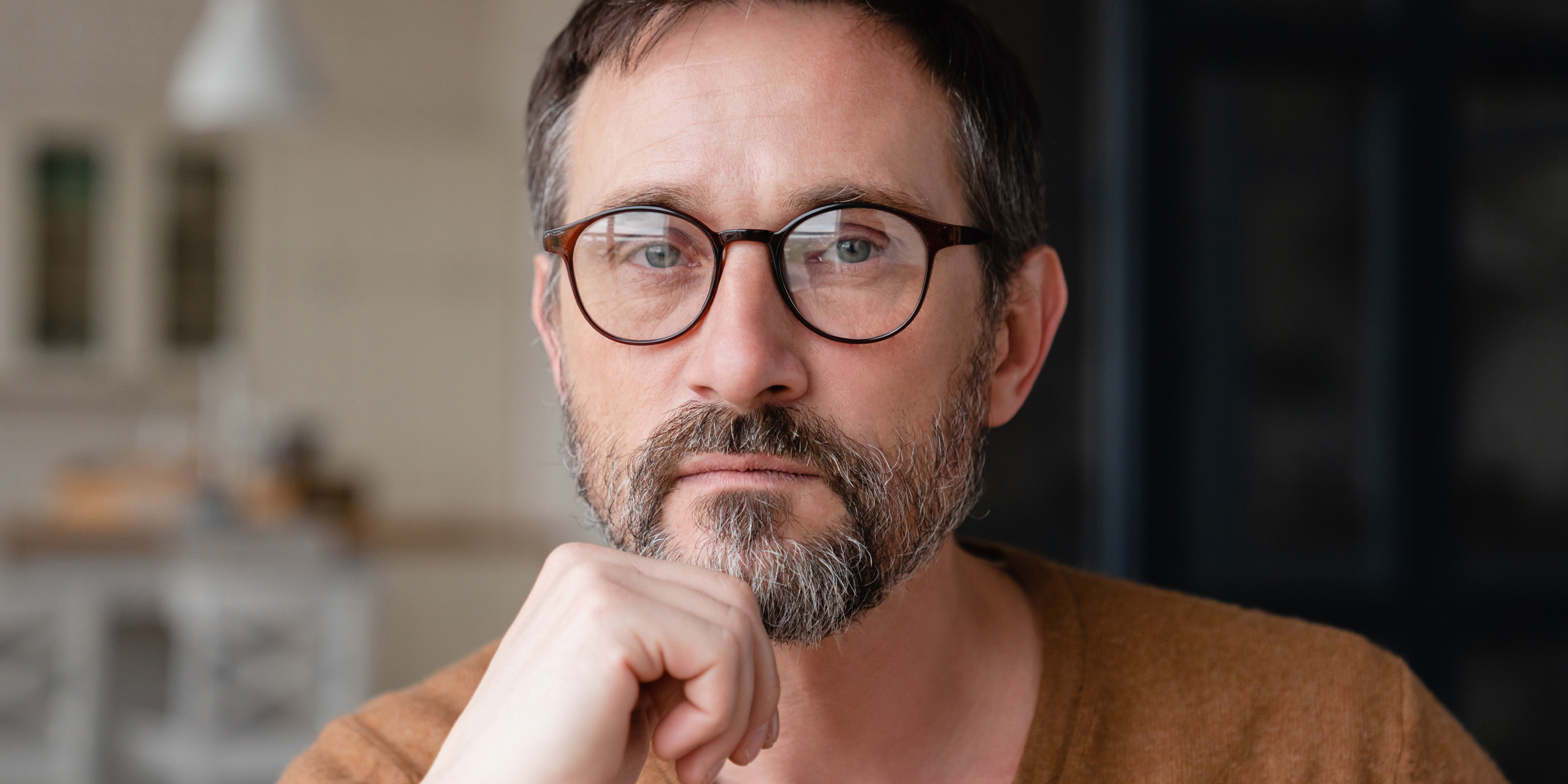 A close up of a pensive man wearing glasses | Source: Shutterstock