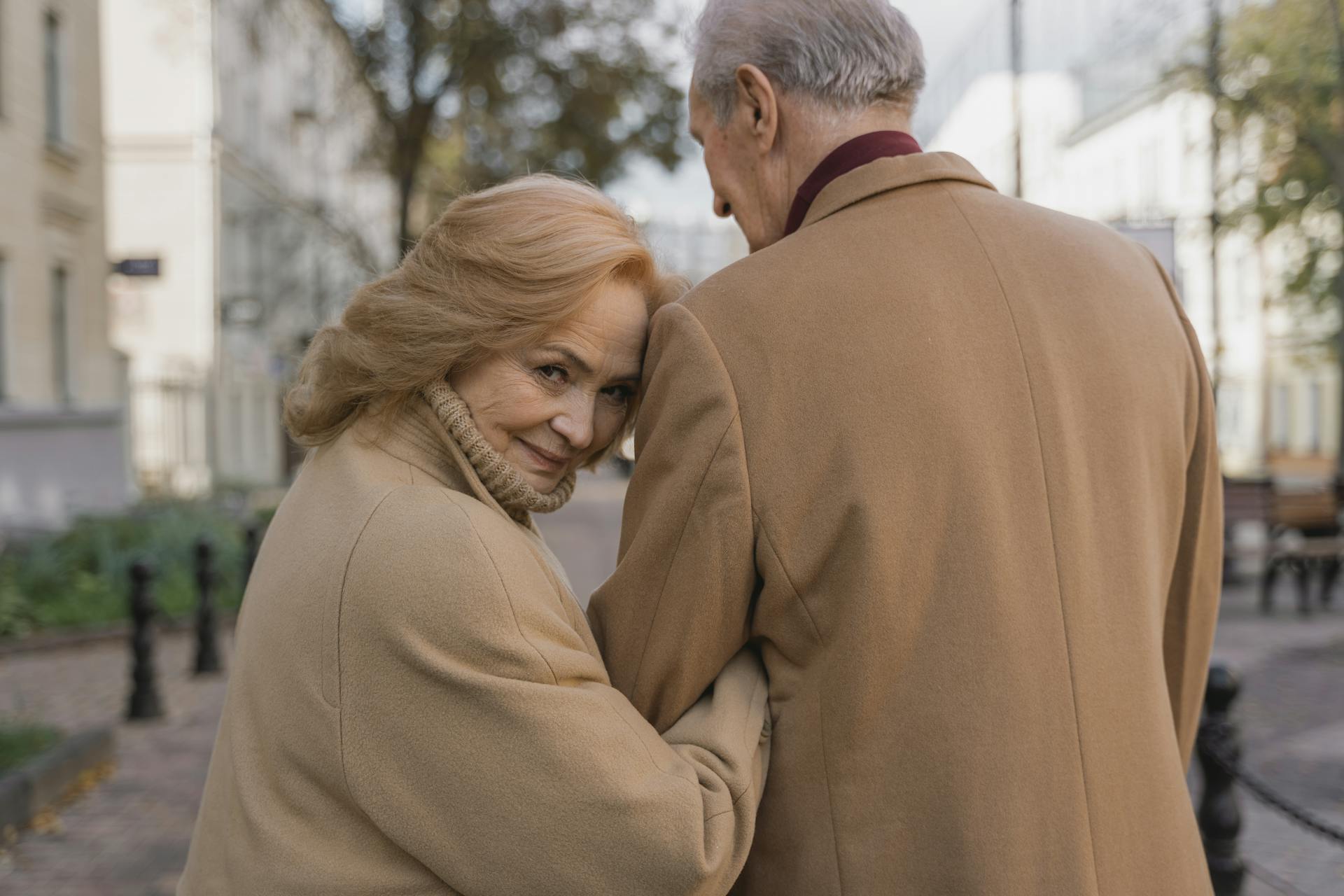 A happy woman looking back while walking with a man | Source: Pexels
