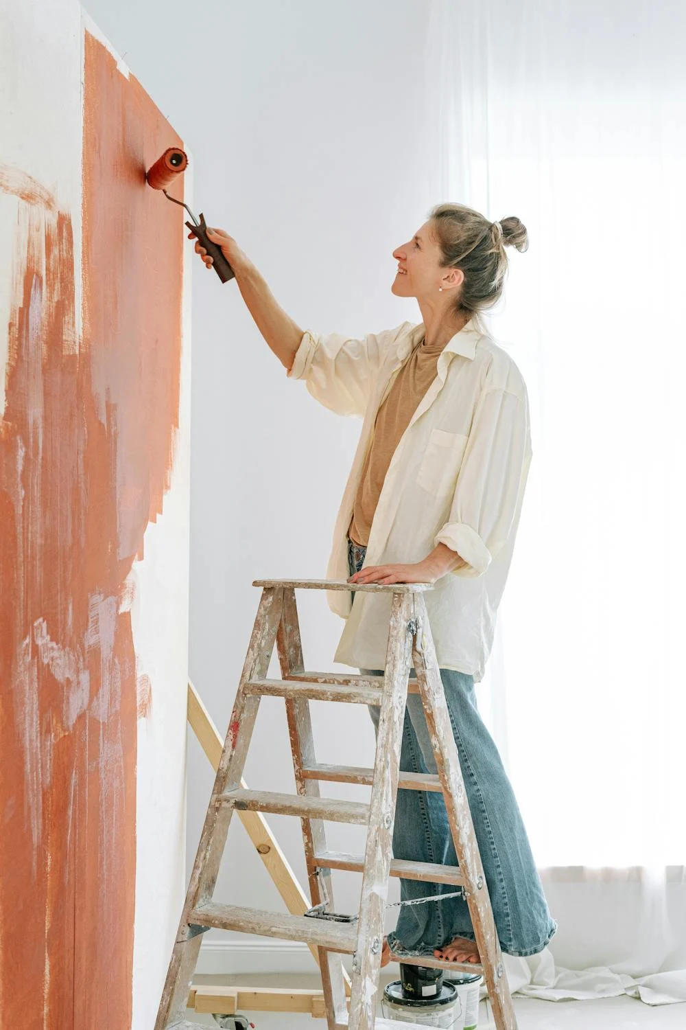 A happy woman painting | Source: Pexels