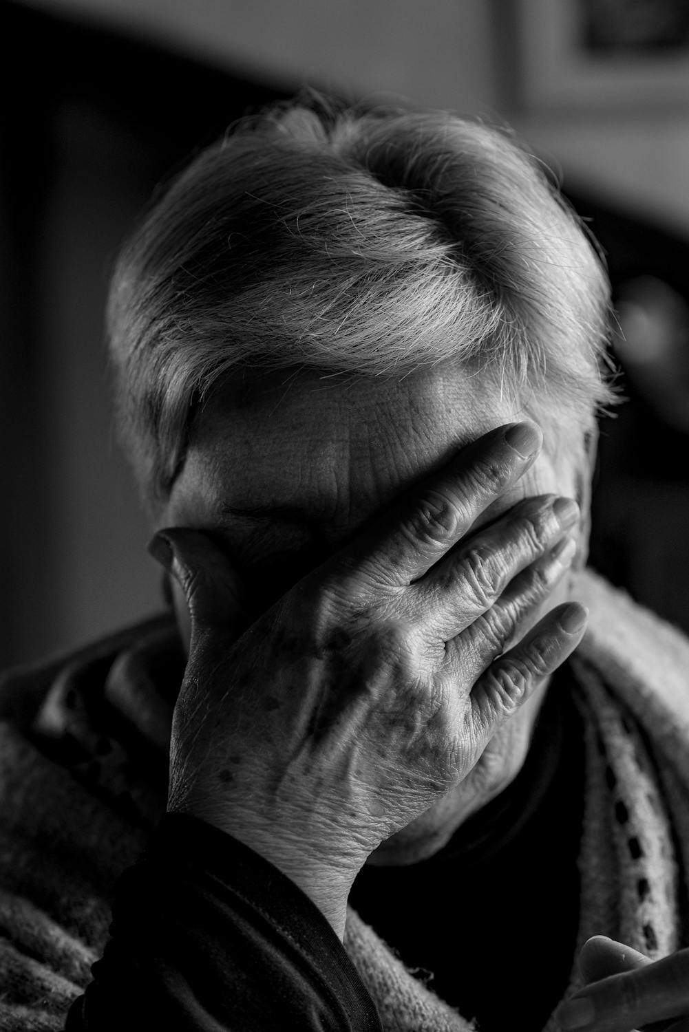 A mature woman covering her face with her hand | Source: Pexels