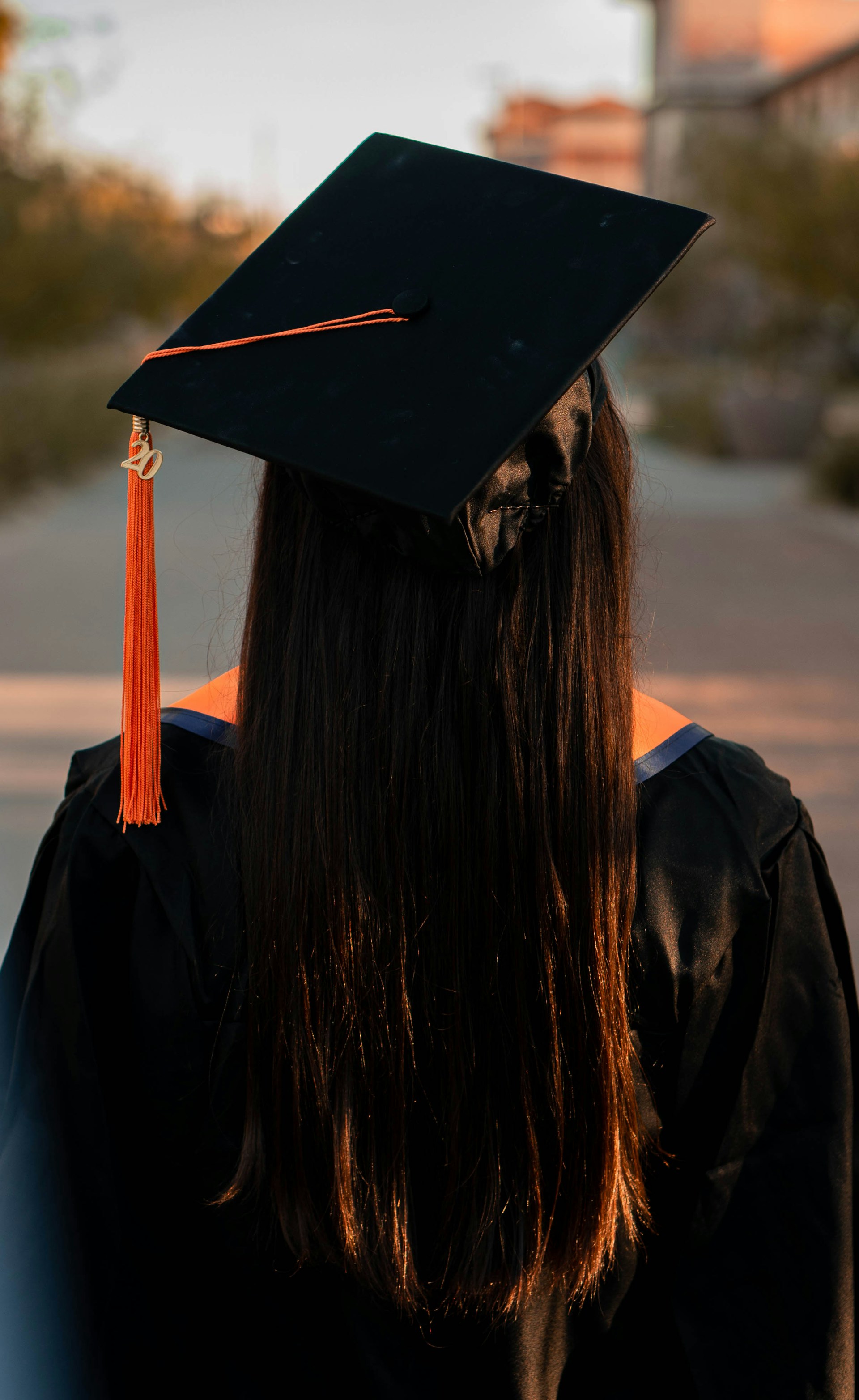 A young graduate standing outside her campus | Source: Unsplash