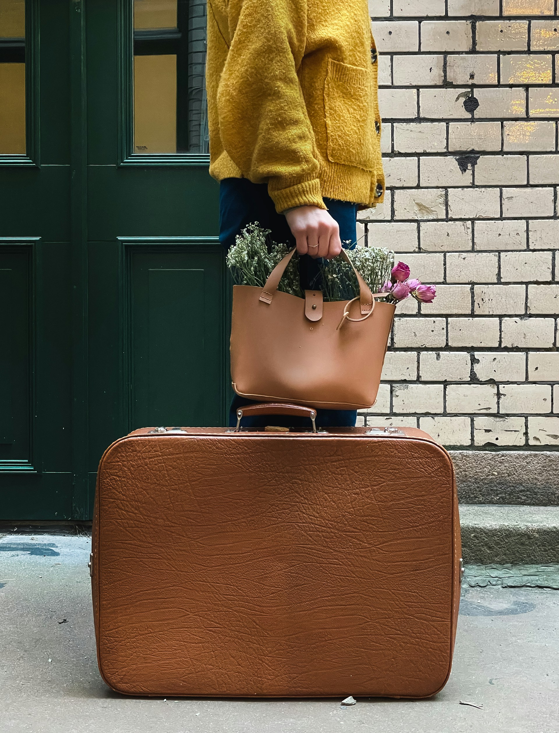 A woman standing beside a suitcase | Source: Unsplash
