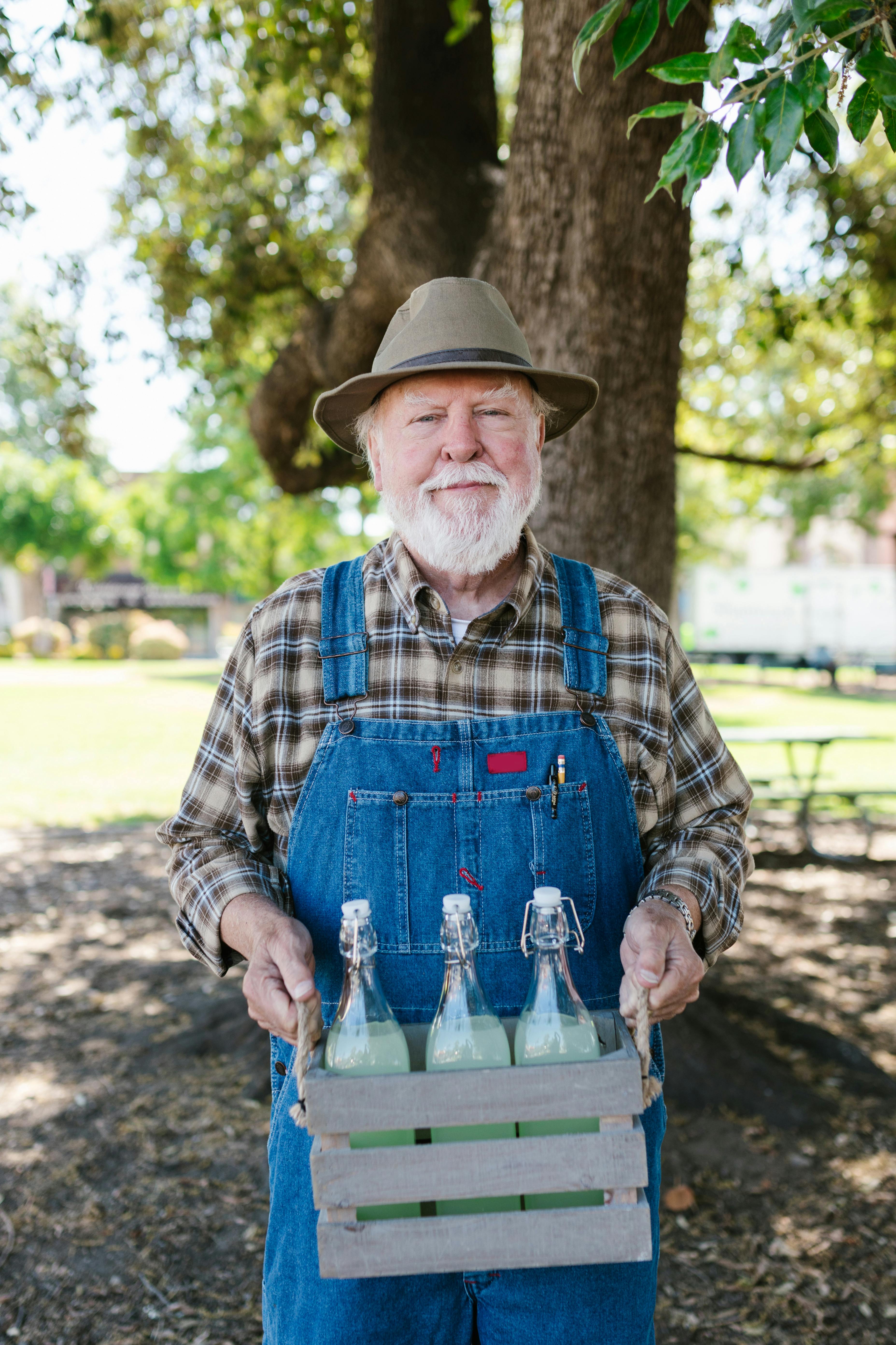 A farmer holding a crate of bottles | Source: Pexels