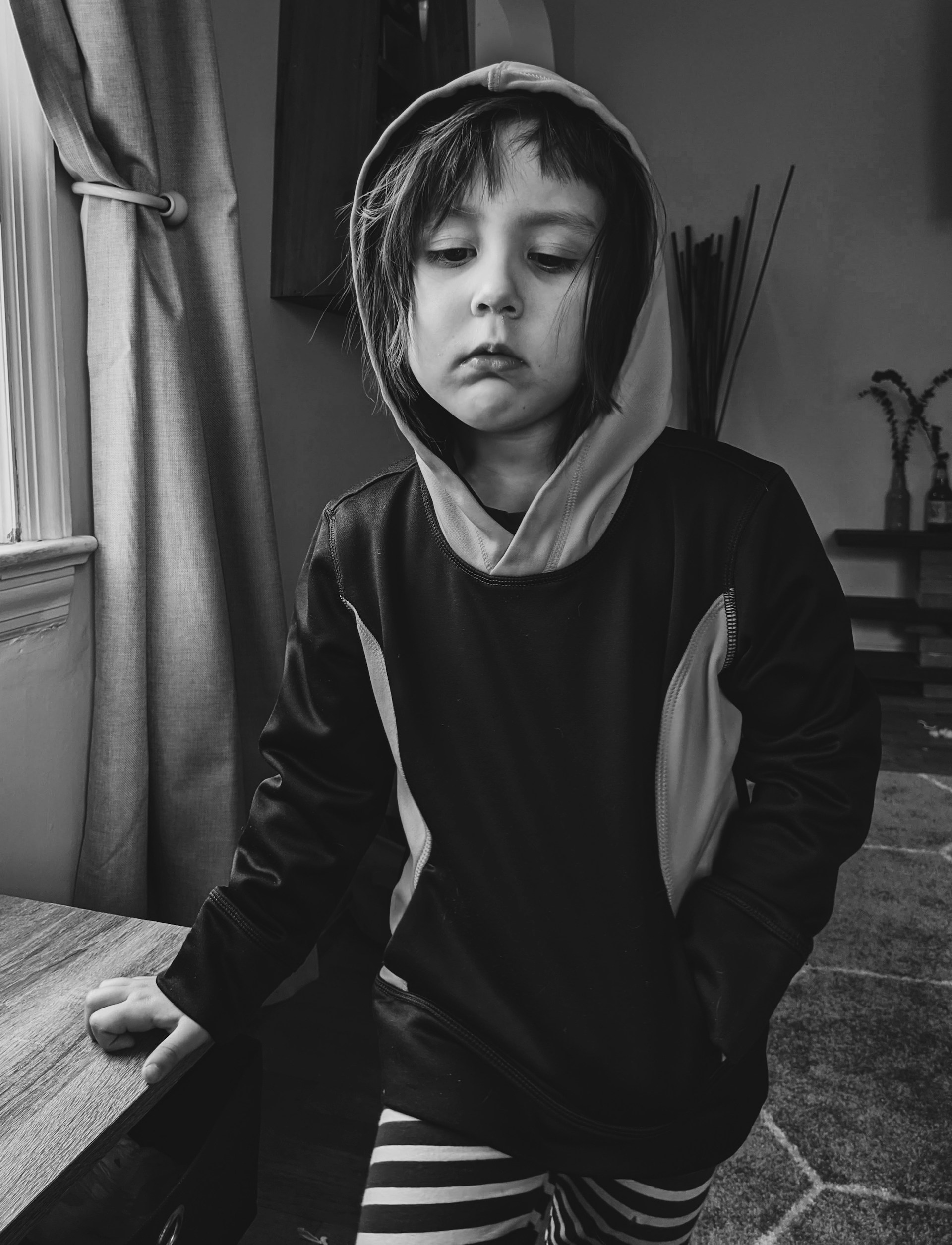 Grayscale shot of a thoughtful child | Source: Unsplash
