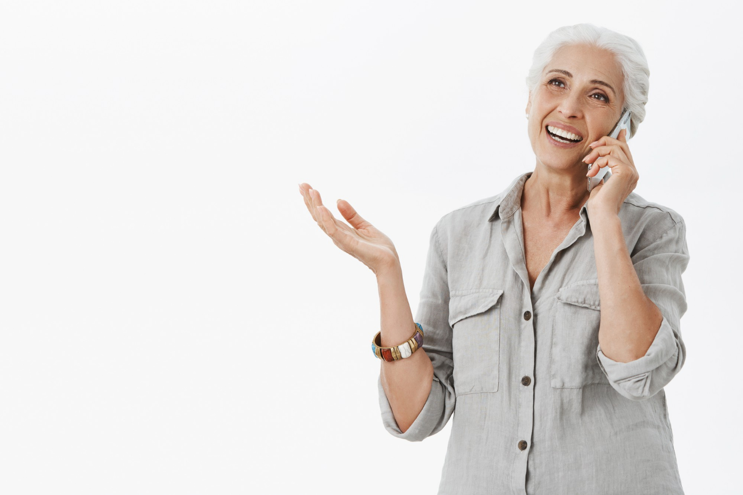 A senior woman talking on the phone | Source: Freepik