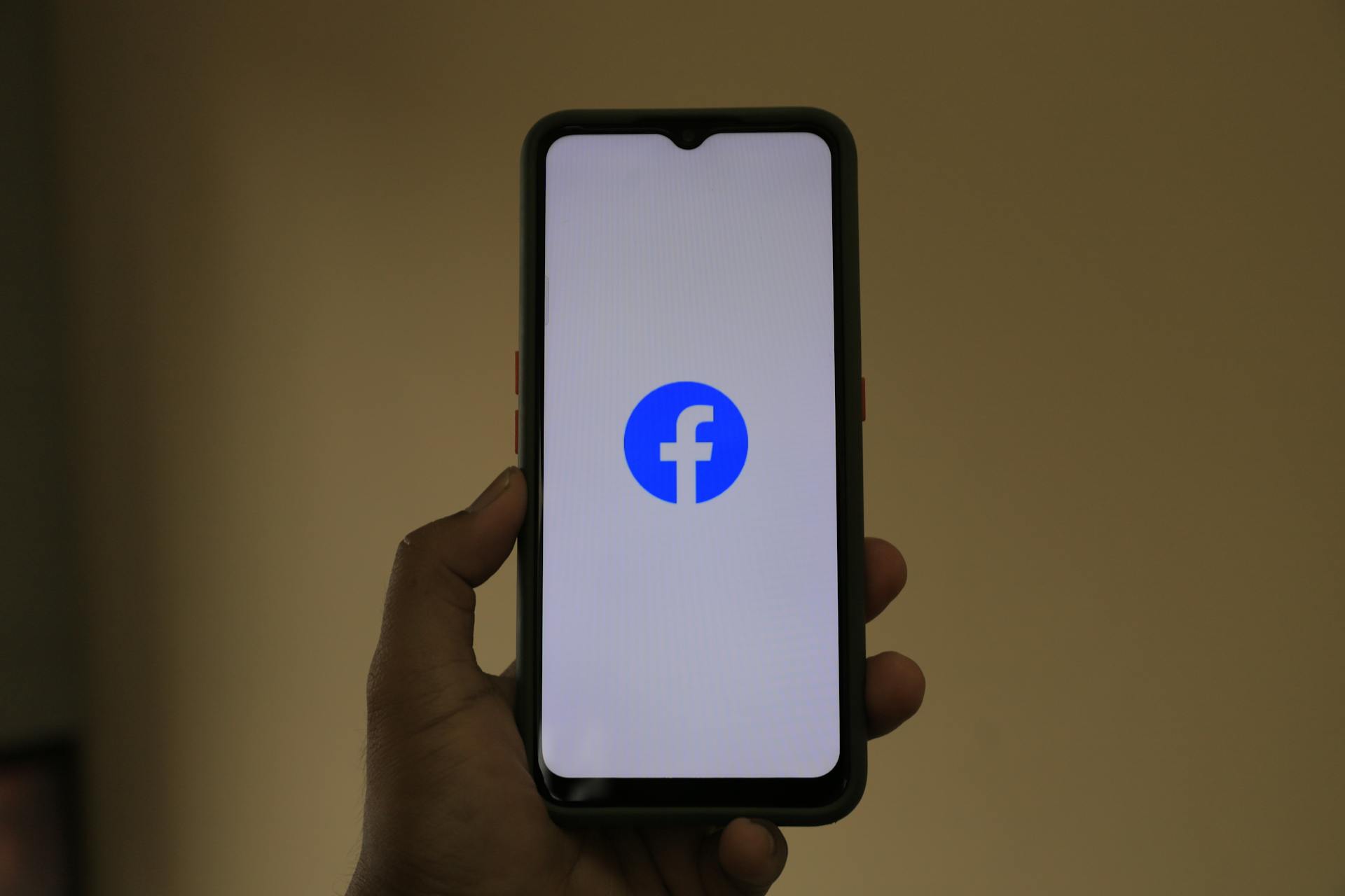 Facebook logo on a phone | Source: Pexels
