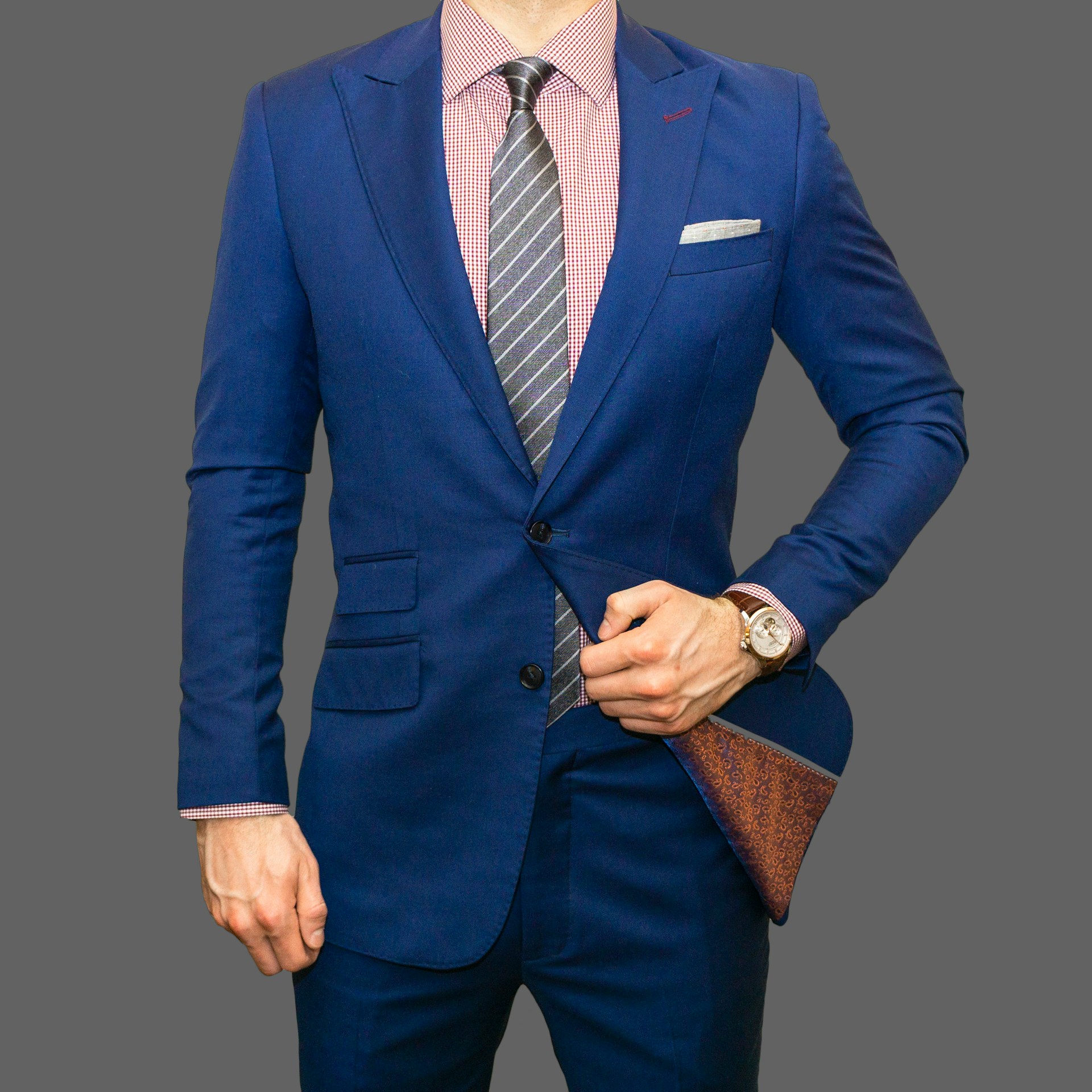 A man wearing a suit and a navy-blue tie with stripes | Source: Unsplash