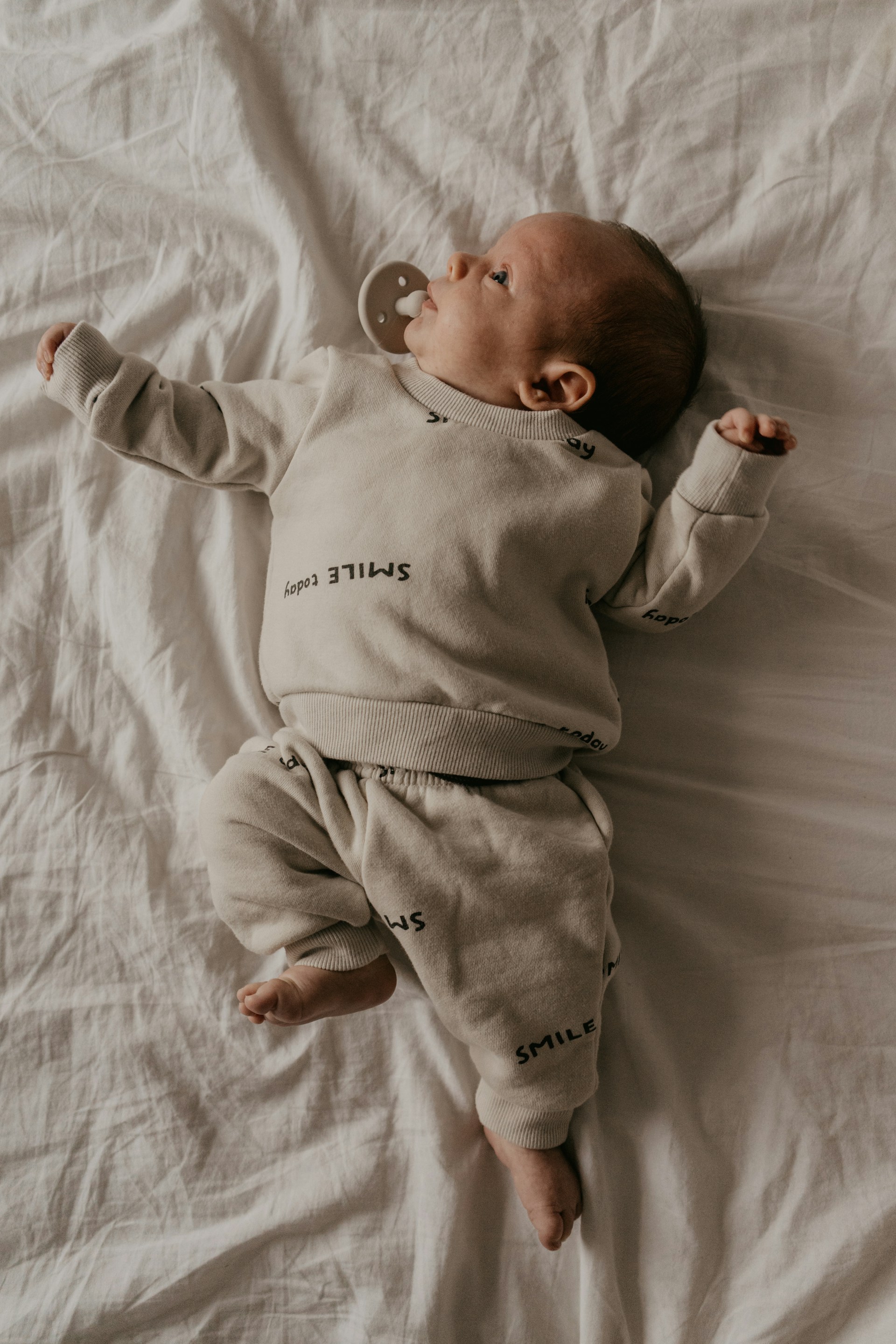 An adorable baby lying on the bed | Source: Unsplash