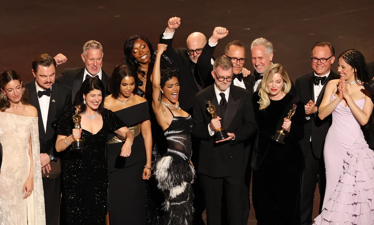 Florencia Martin, Leonardo DiCaprio, Cassandra Kulukundis, James Raterman, Shayna McHayle, Regina Hall, Teyana Taylor, Michael Bauman, Anthony Carlino, Will Weiske, Paul Thomas Anderson, Sara Murphy and Chase Infiniti celebrate the award for Best Picture for "One Battle After Another" onstage during the 98th Annual Academy Awards at the Dolby Theatre in Hollywood, California on March 15, 2026. | Source: Getty Images
