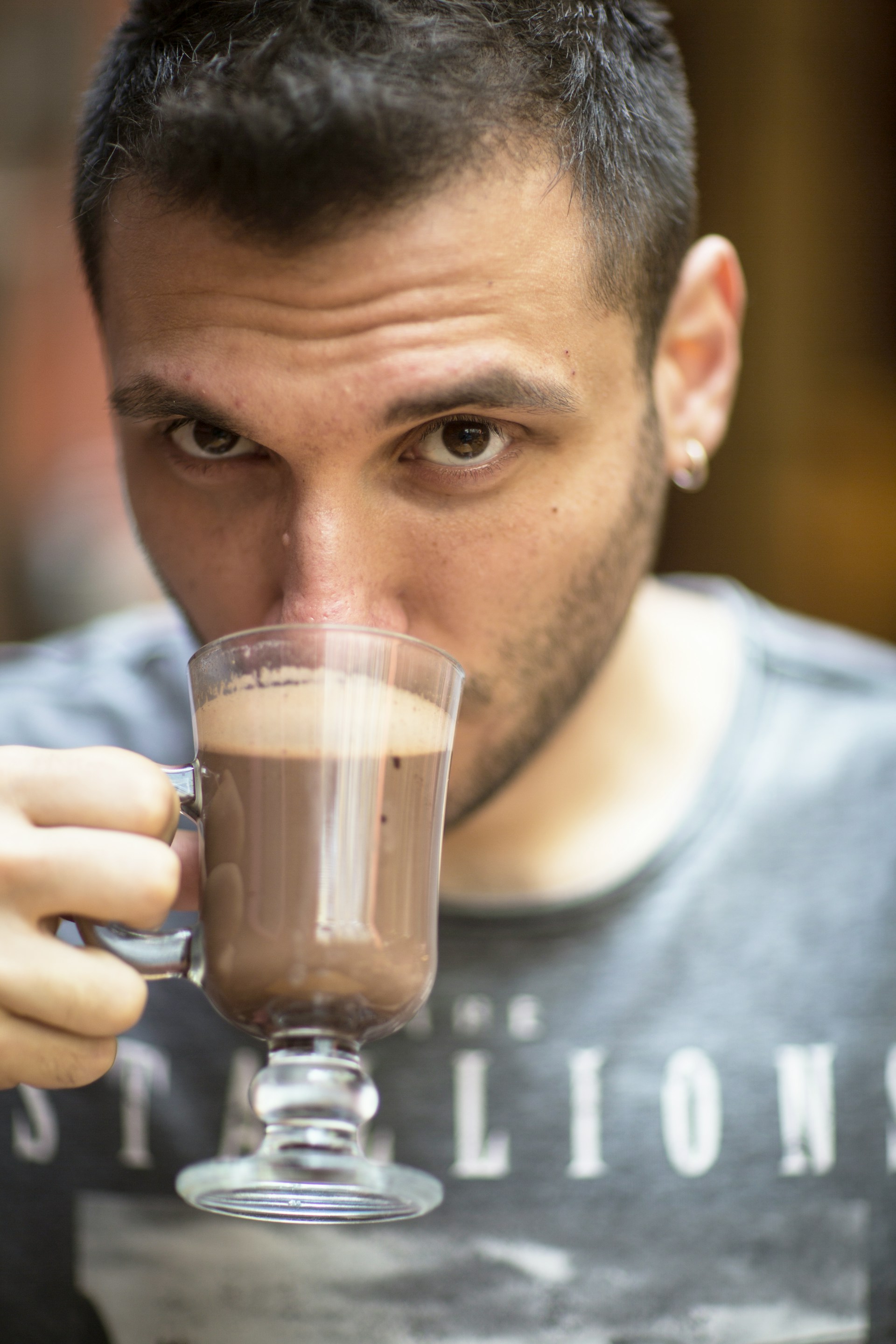 A man staring while drinking a beverage | Source: Unsplash