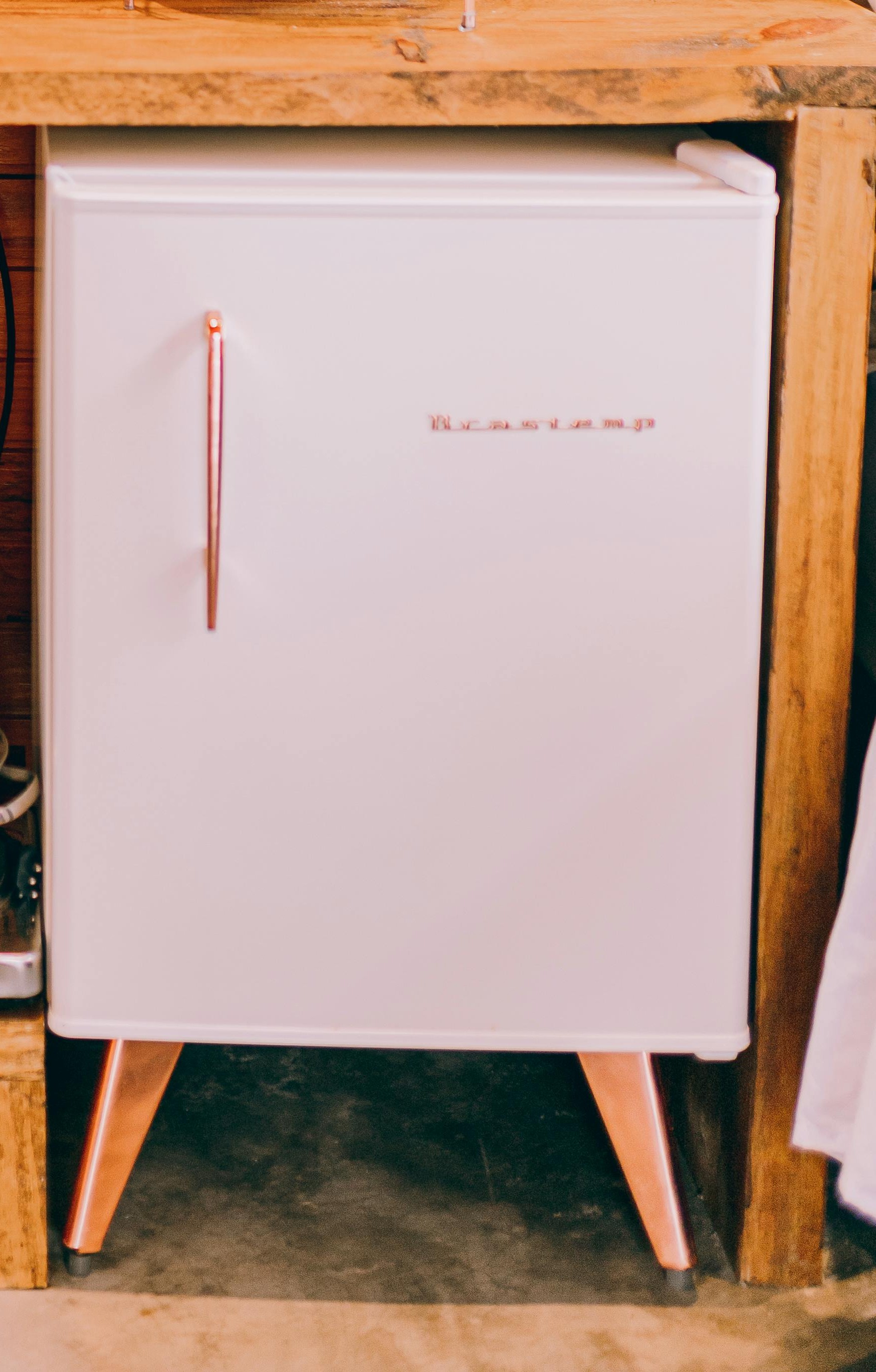 A mini fridge under the desk | Source: Pexels