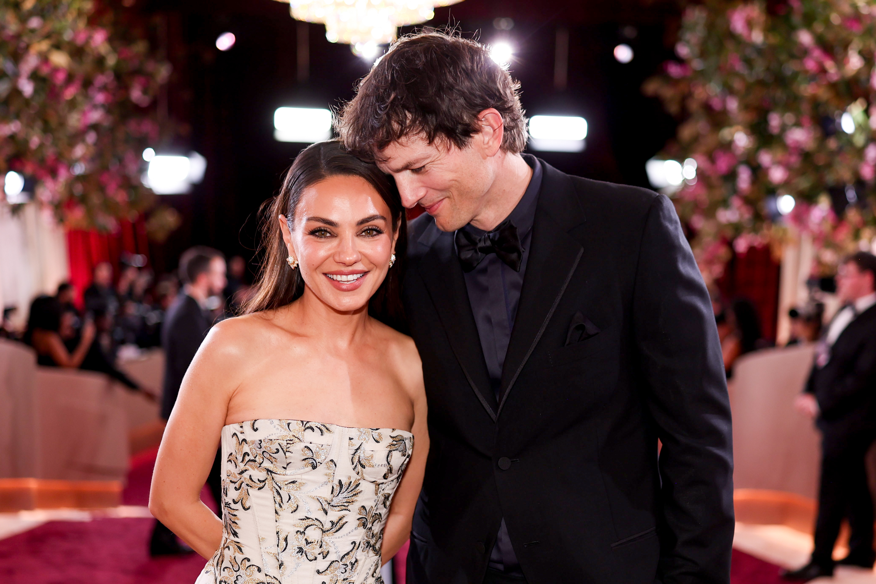 Mila Kunis and Ashton Kutcher smile as they take photos at the Annual Golden Globes in Beverly Hills, California on January 11, 2026. | Source: Getty Images