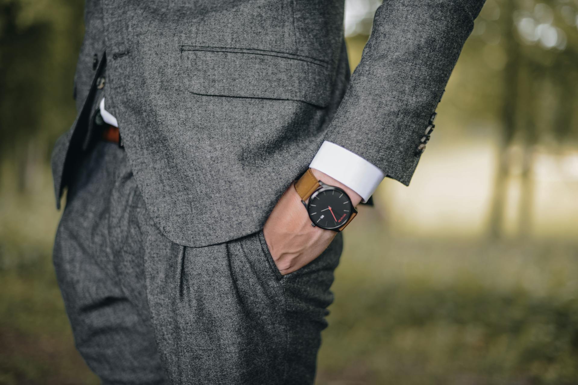 A close-up shot of a man in a gray suit with his hands in his pockets | Source: Pexels