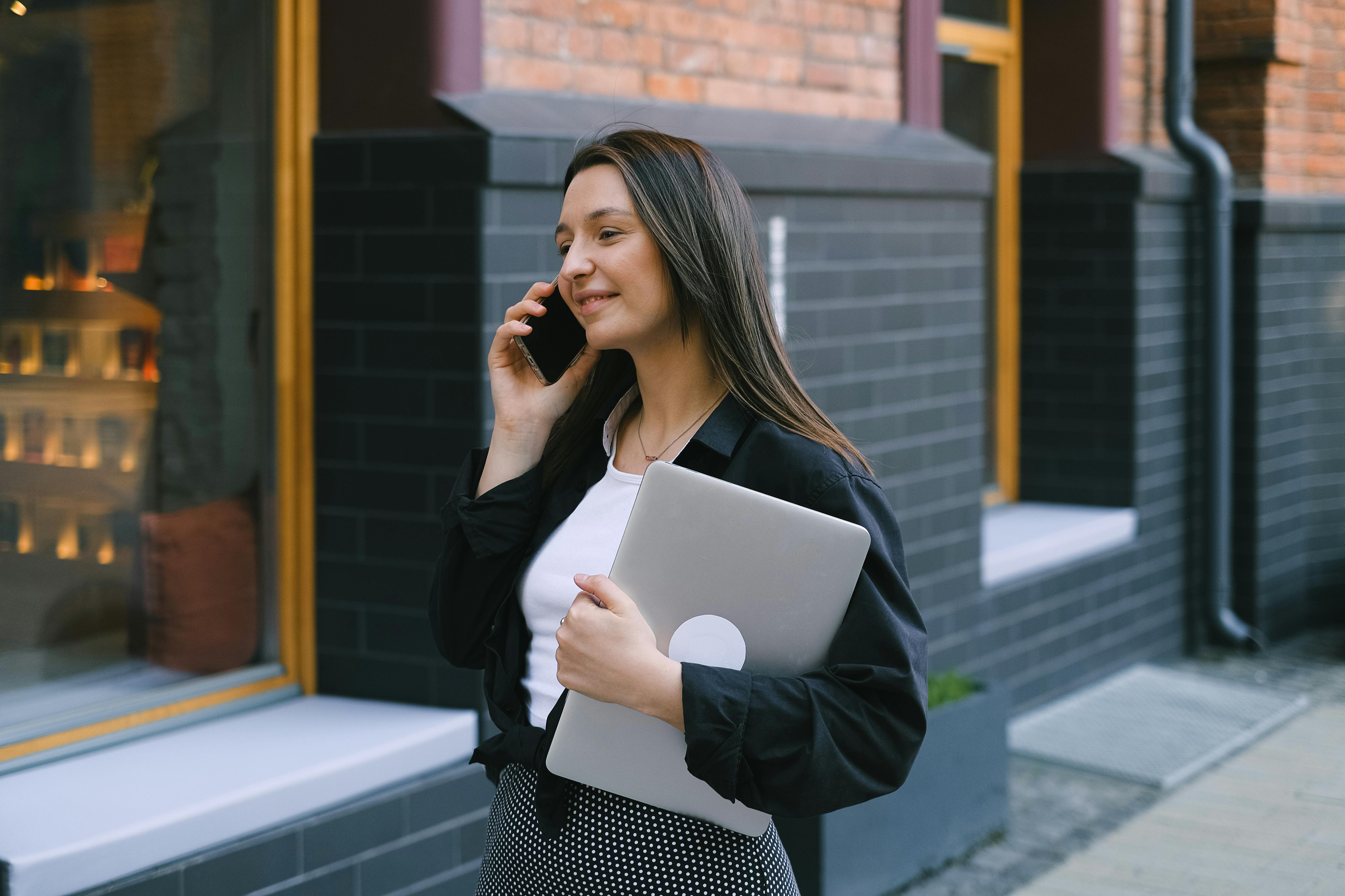 Woman walking on the sidewalk while on a phone call | Source: Pexels
