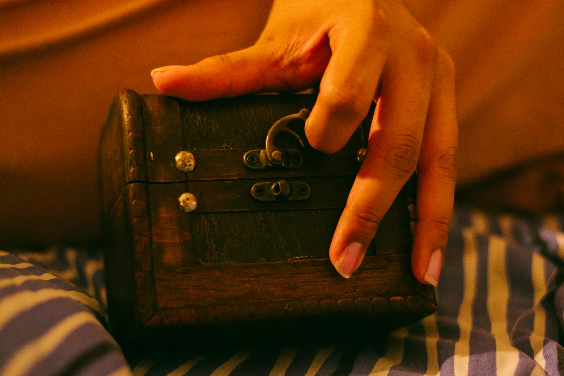 A woman opening a small wooden box | Source: Pexels